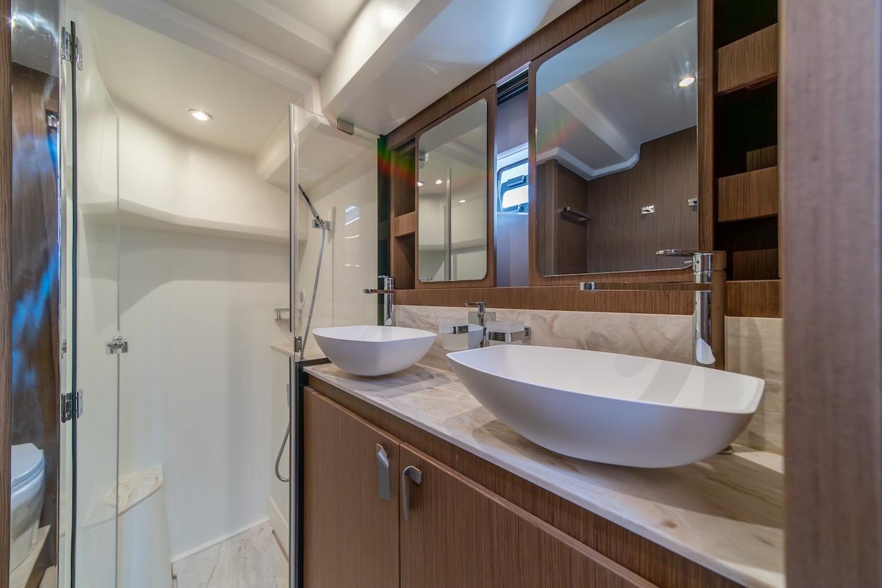 Luxurious bathroom in 2025 Prestige F4.9 yacht with dual sinks and modern fixtures.