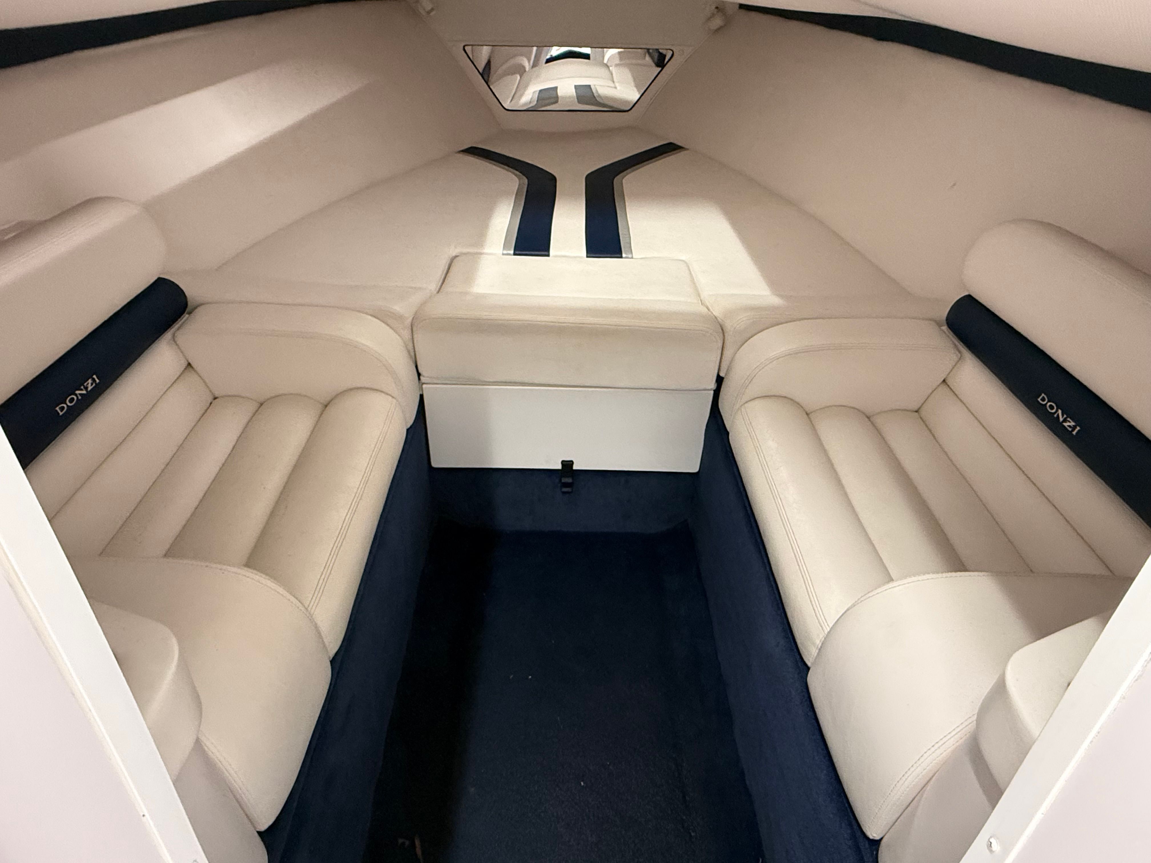 Interior of a 2003 Donzi 28 ZX with beige upholstery and blue accents.