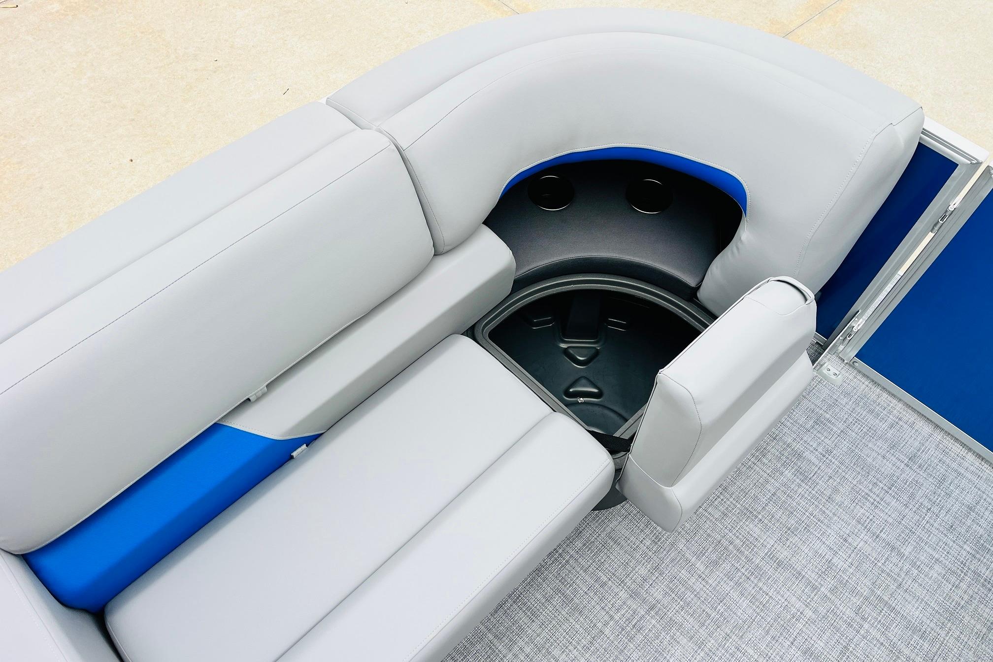2026 Sun Tracker Party Barge 22 RF DLX seating area with storage compartment.