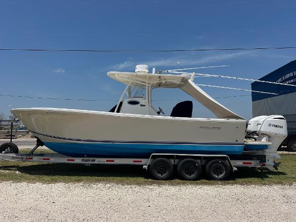 2016 Regulator center console boat on trailer with Yamaha engine, parked outdoors.