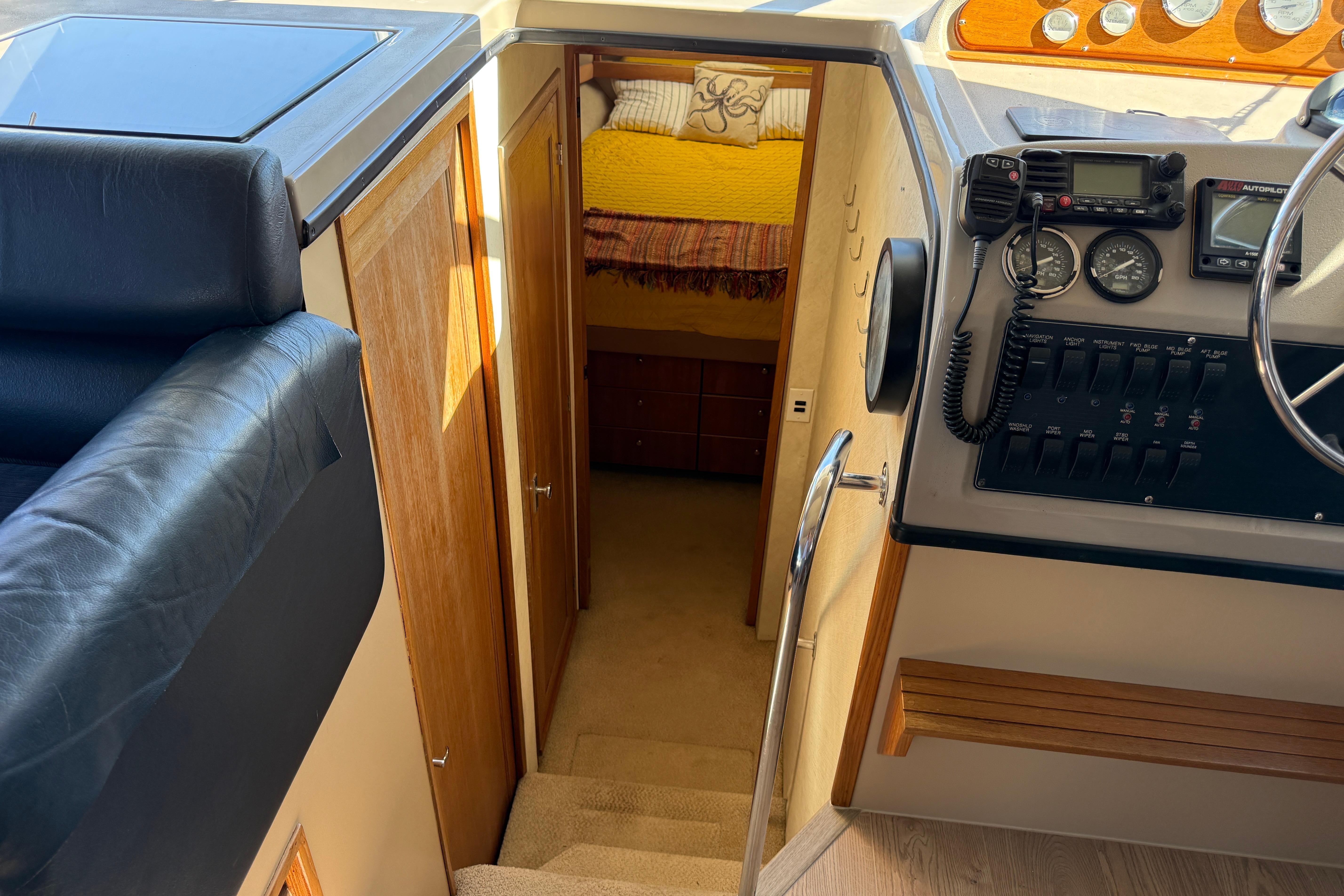 1997 Bayliner 3988 Command Bridge Motoryacht interior with helm, stairs, and cozy cabin view.