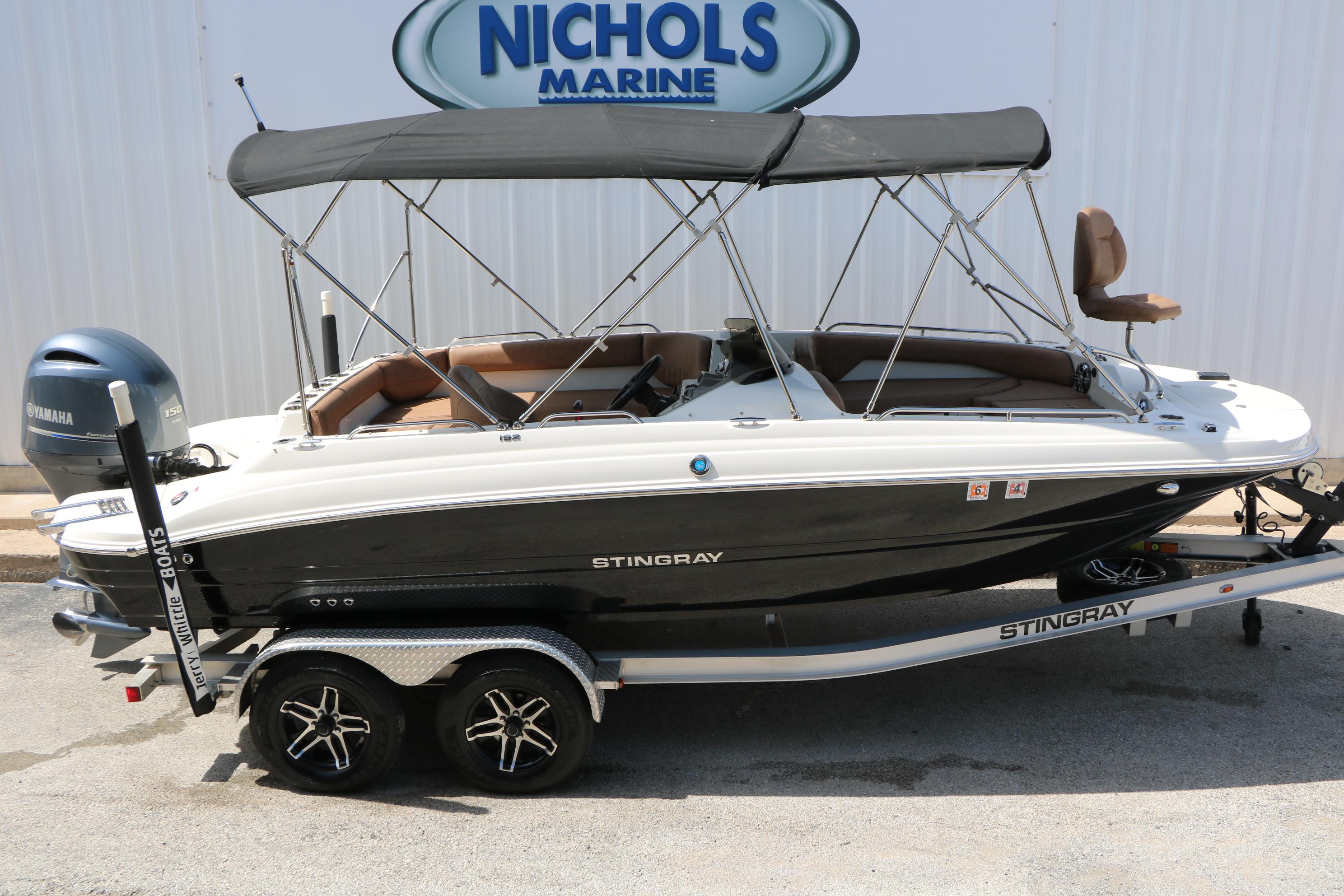 2022 Stingray 192 SC boat with canopy on trailer at Nichols Marine dealership.