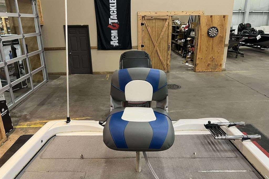 2005 Nitro NX 750 boat interior with blue and gray seating in a garage setting.