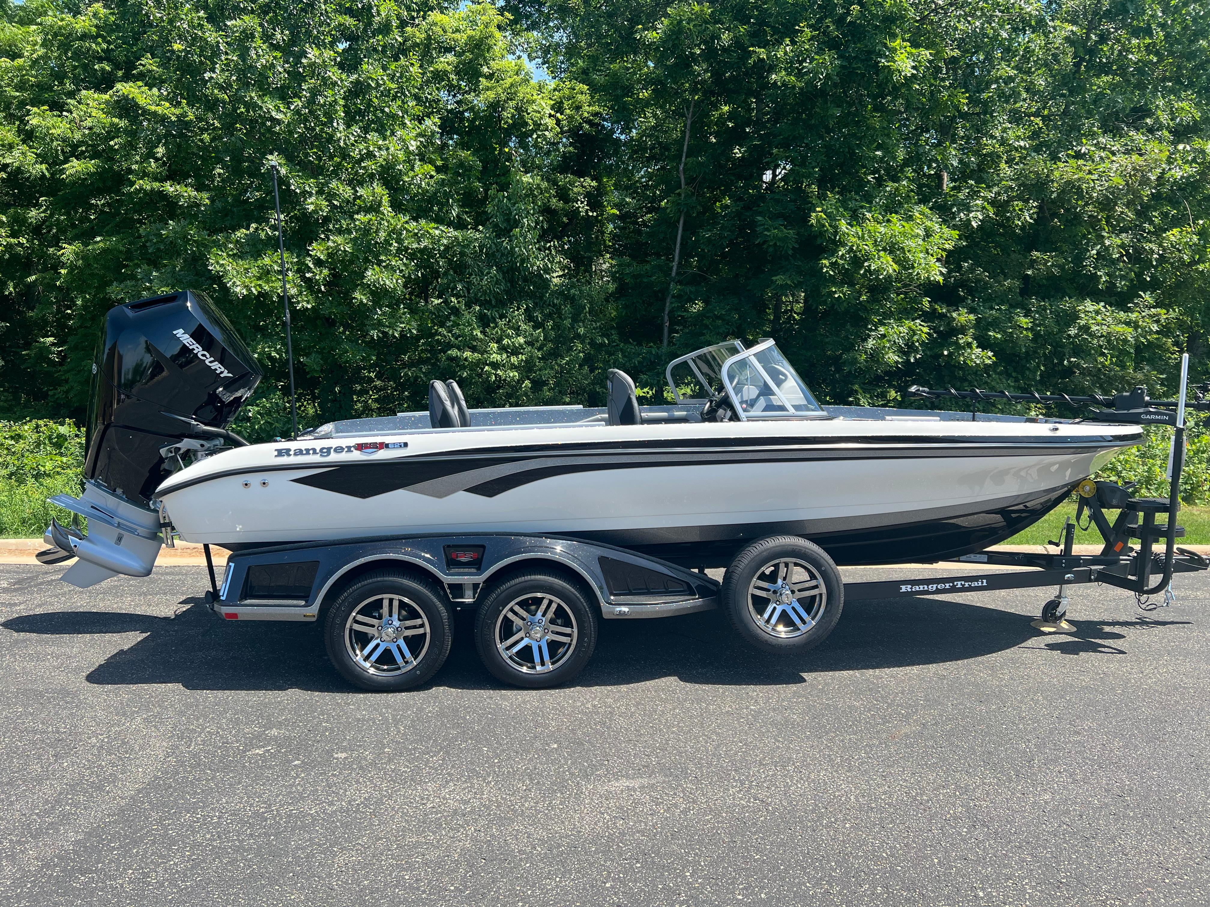 2025 Ranger 621FS Cup Equipped boat on trailer, parked outdoors with lush green background.