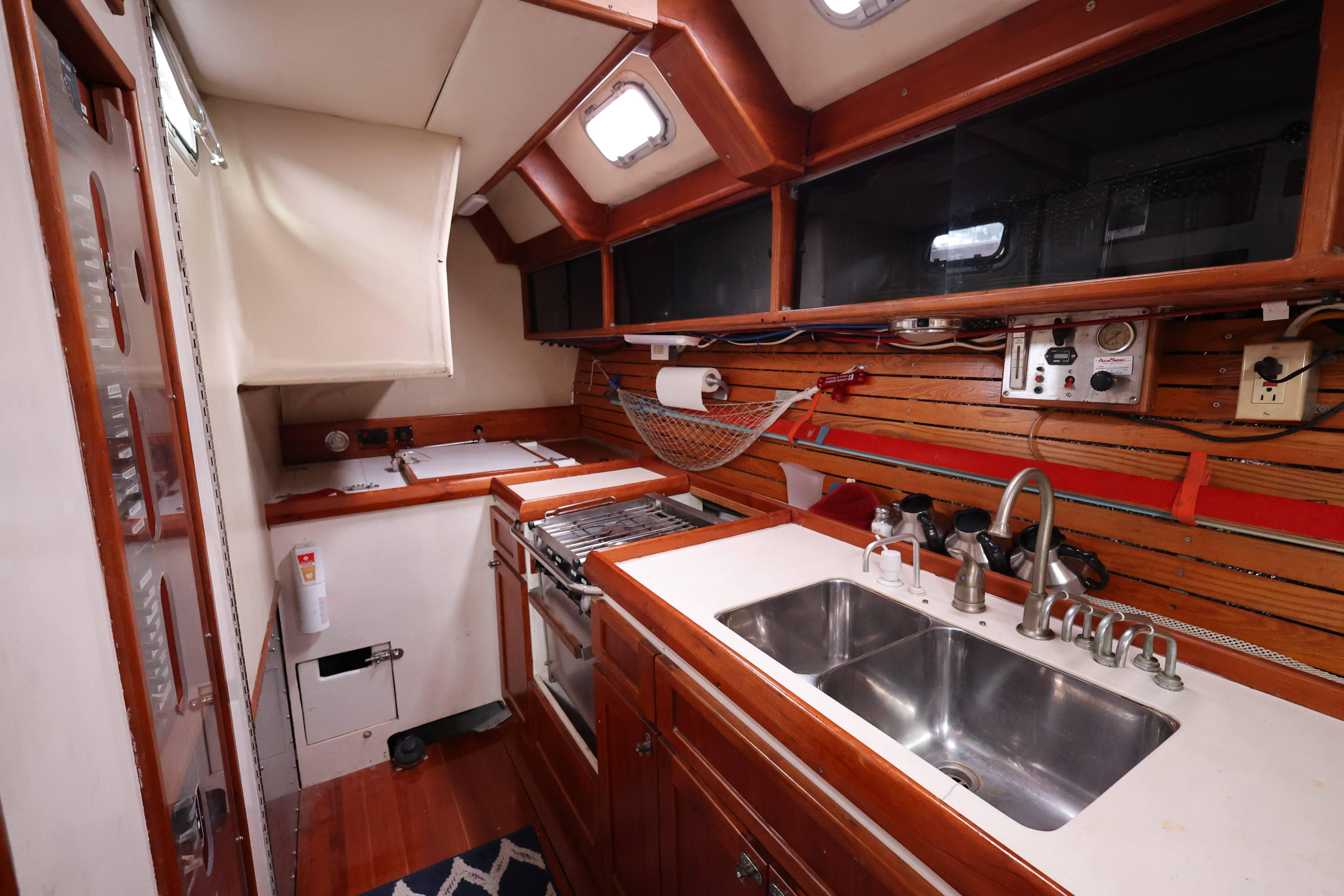 1998 Limited Edition Hike Metal yacht kitchen with dual sinks and wooden cabinetry.
