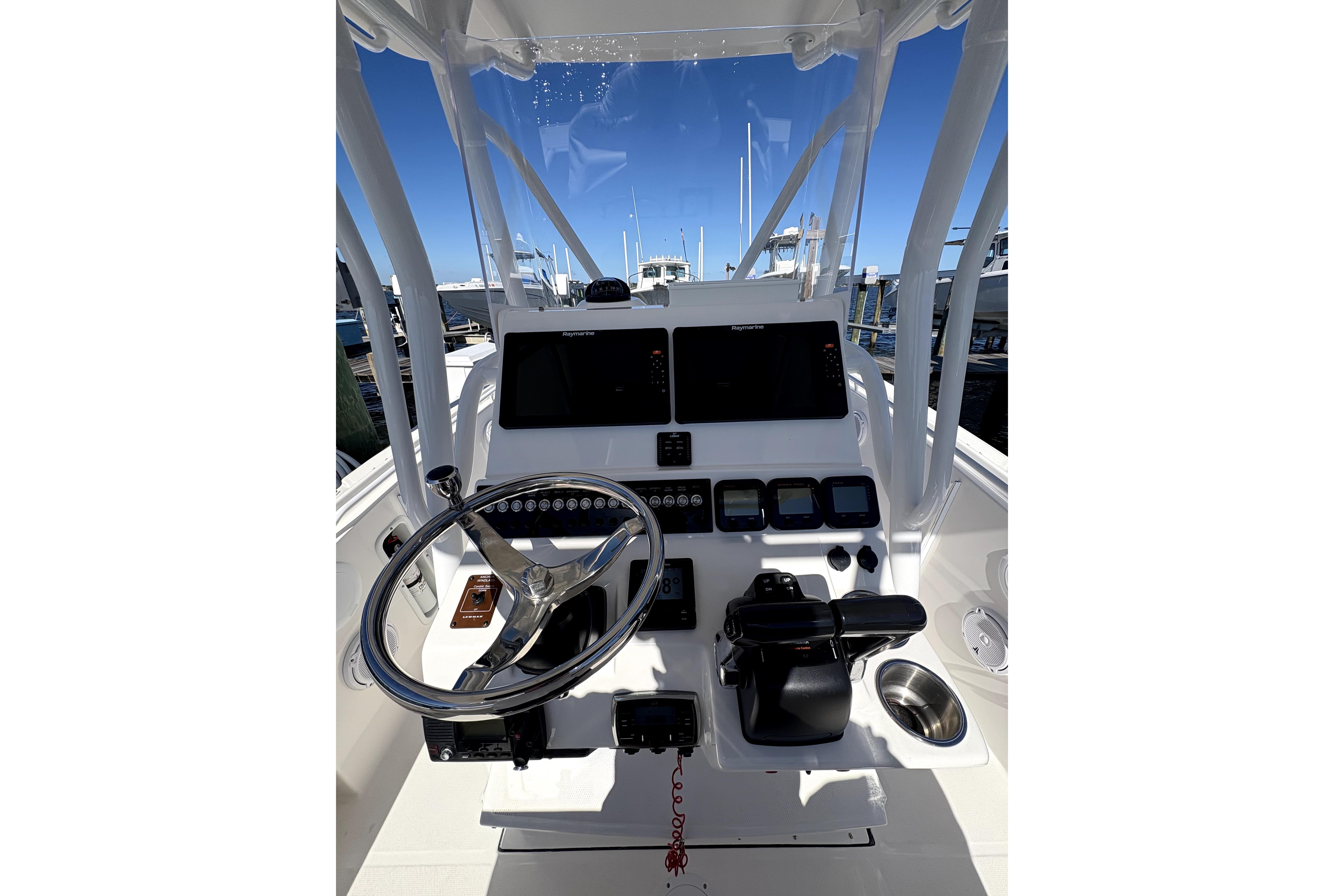 2015 Edgewater 245CC boat console with steering wheel and navigation controls.