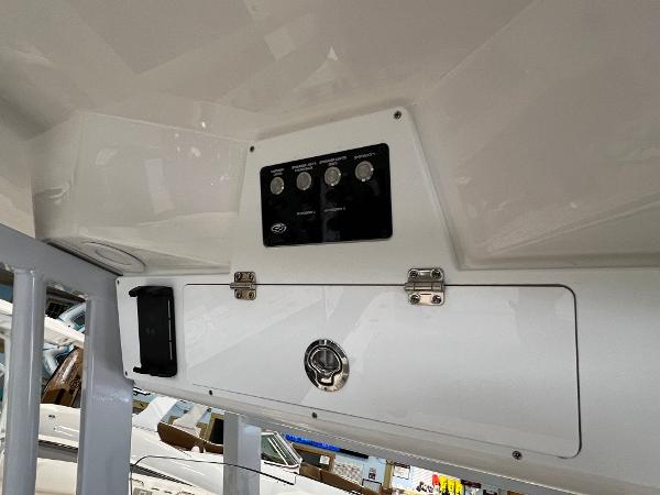 2024 Sea Fox 231 Bay boat control panel and storage compartment.