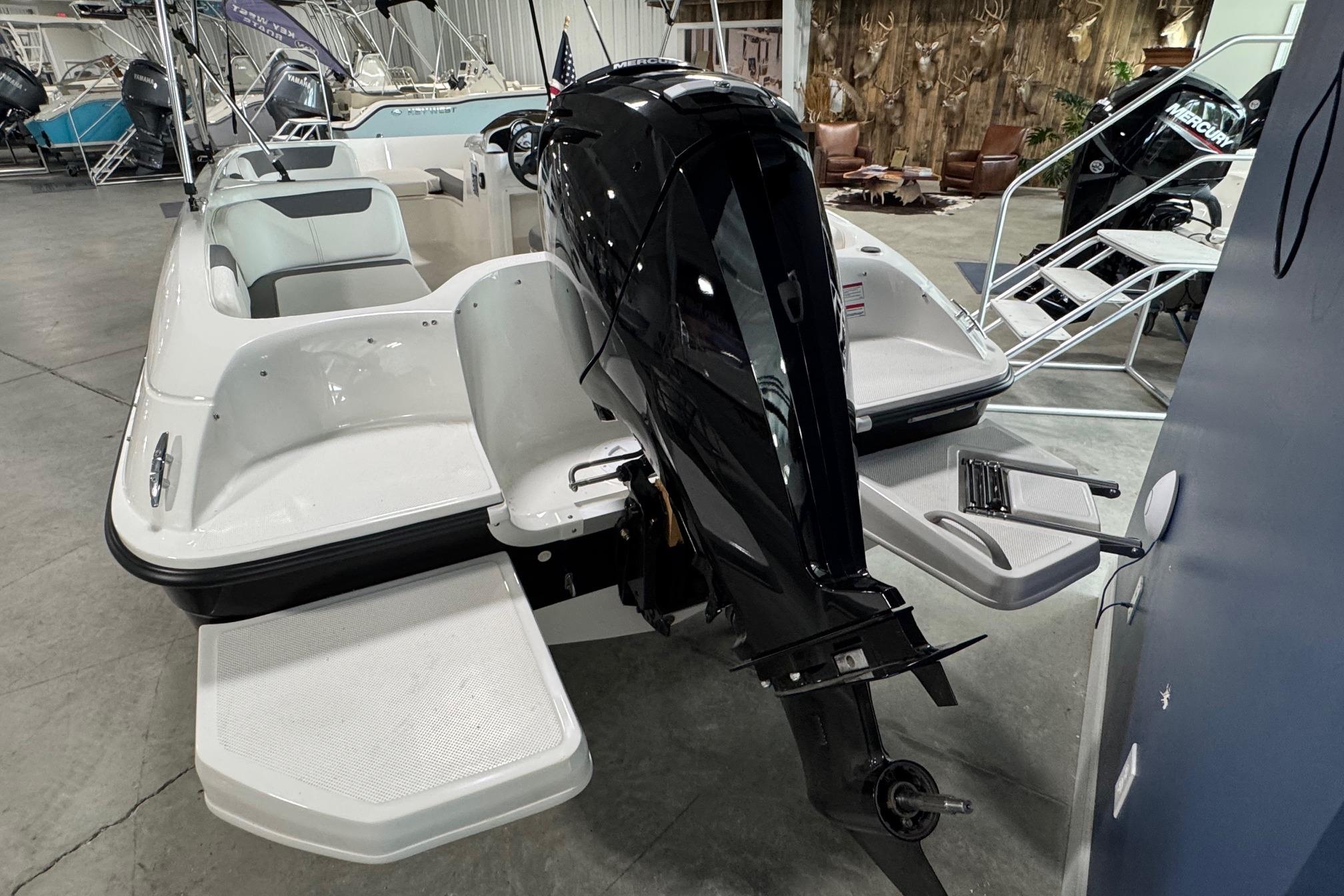 2026 Bayliner Element E18 boat with outboard motor in showroom.