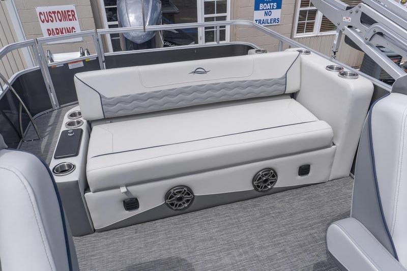 Luxury seating on 2026 SunCatcher Elite 326 SL boat, featuring cup holders and speakers.