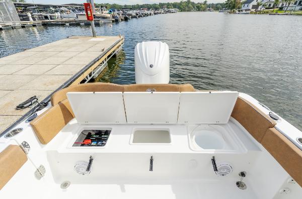 2025 Sea Hunt Ultra 235 SE boat at dock, featuring open storage compartments.
