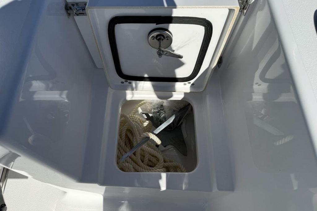 2026 Sportsman Open 232 Center Console anchor storage with rope and anchor visible.
