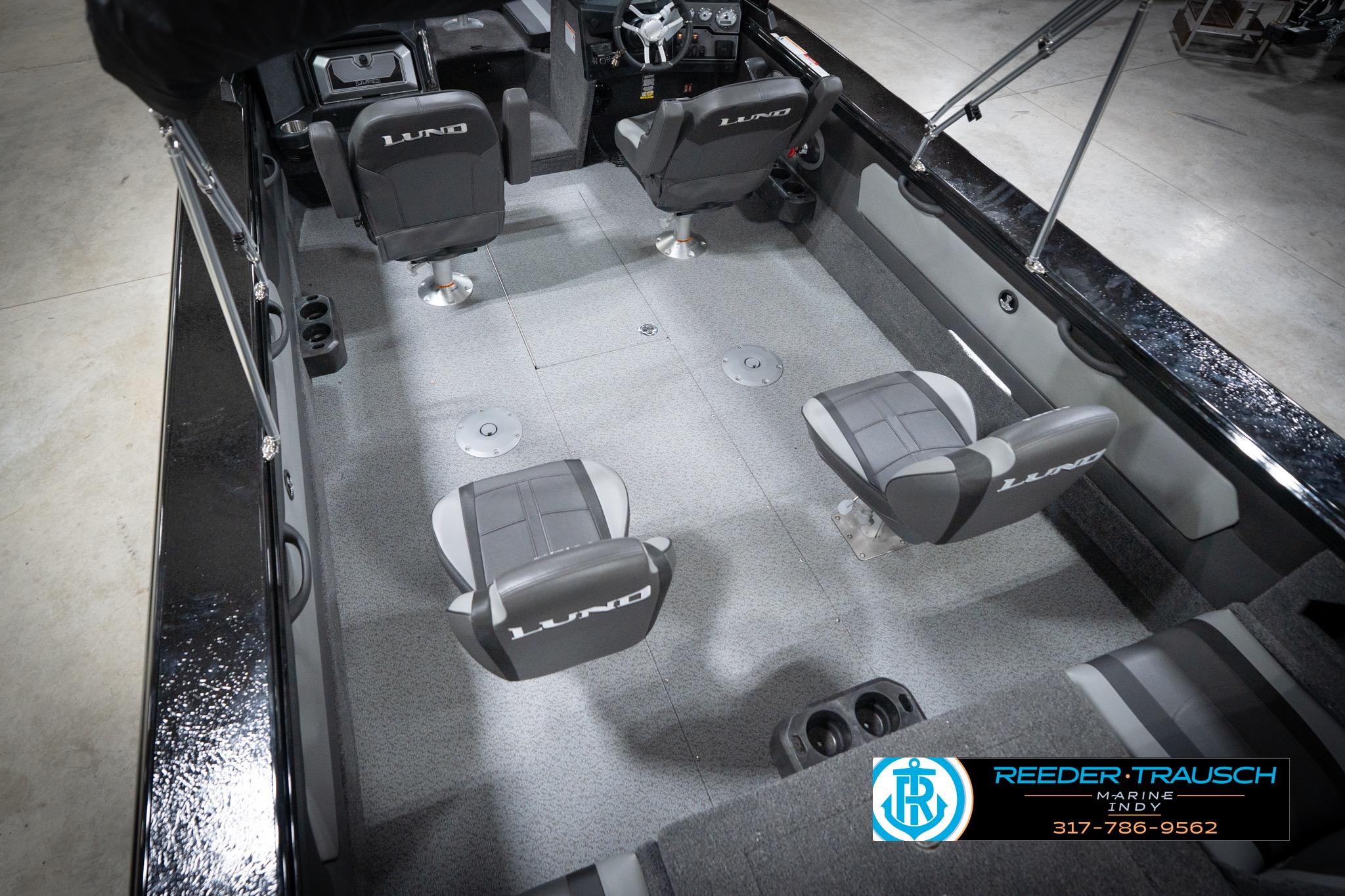 2026 Lund 2275 Baron boat interior with four seats and steering console.