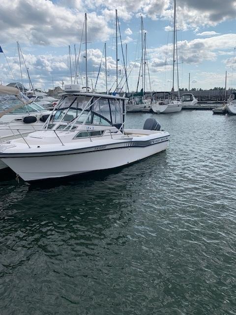 1994 Grady-White Seafarer 22 boat docked in a marina with sailboats.