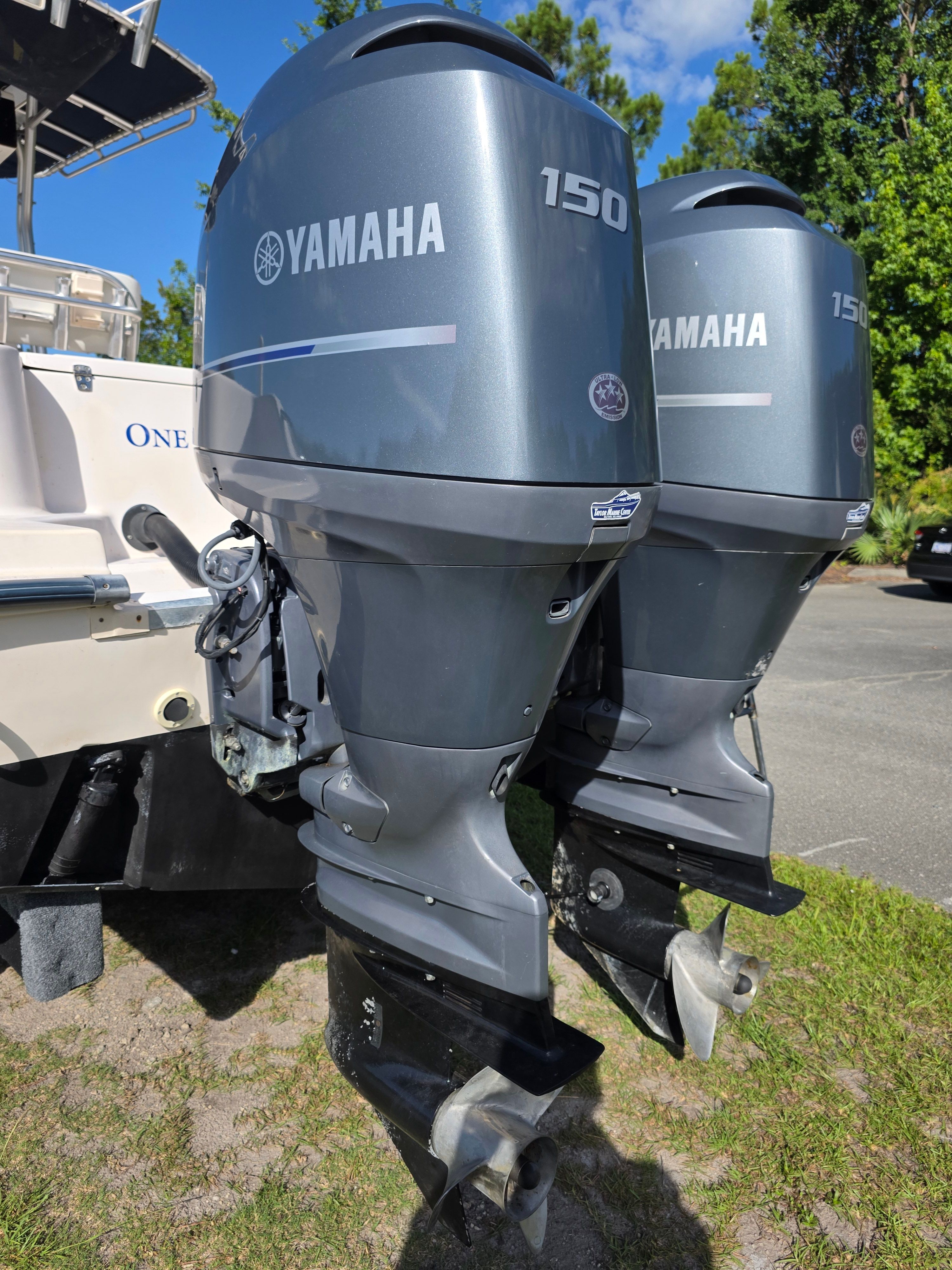Two Yamaha 150 outboard engines are mounted on the stern of a Grady-White 257 boat.
