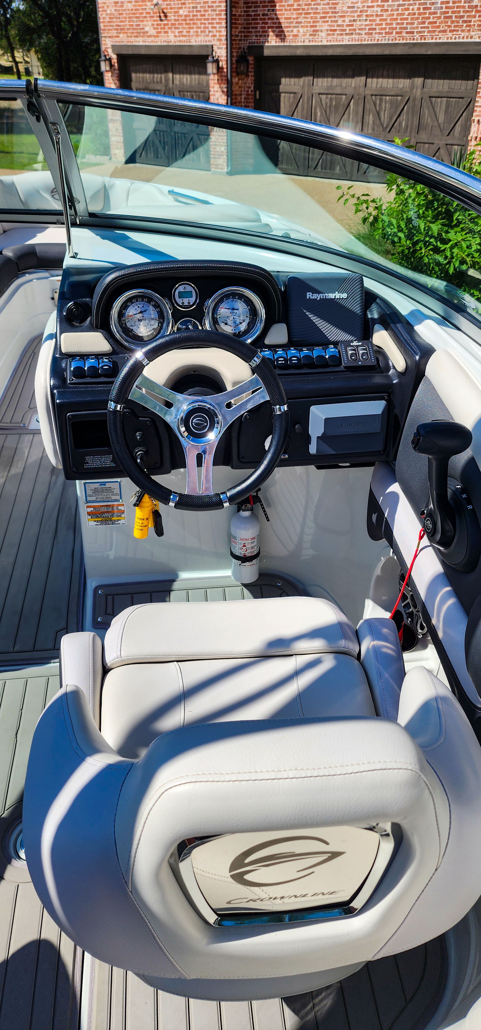 The image shows the cockpit of a 2017 Crownline 285SS boat with a sleek steering wheel.