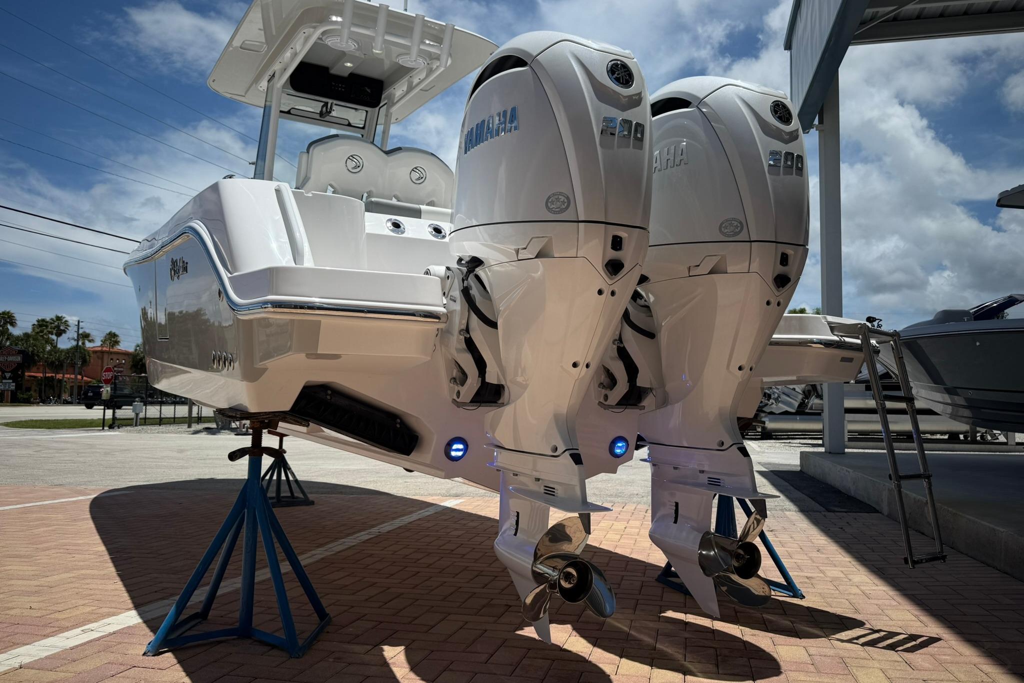 2026 Edgewater 250CC boat with dual Yamaha outboard engines on display.