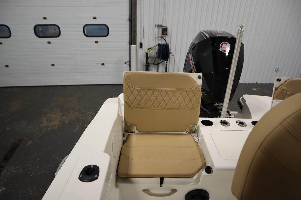 2026 Bayliner Trophy T20CC boat interior with tan seating and outboard motor.