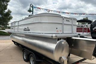 2026 Sun Tracker Party Barge 22 XP3 pontoon boat on trailer, outdoor display.