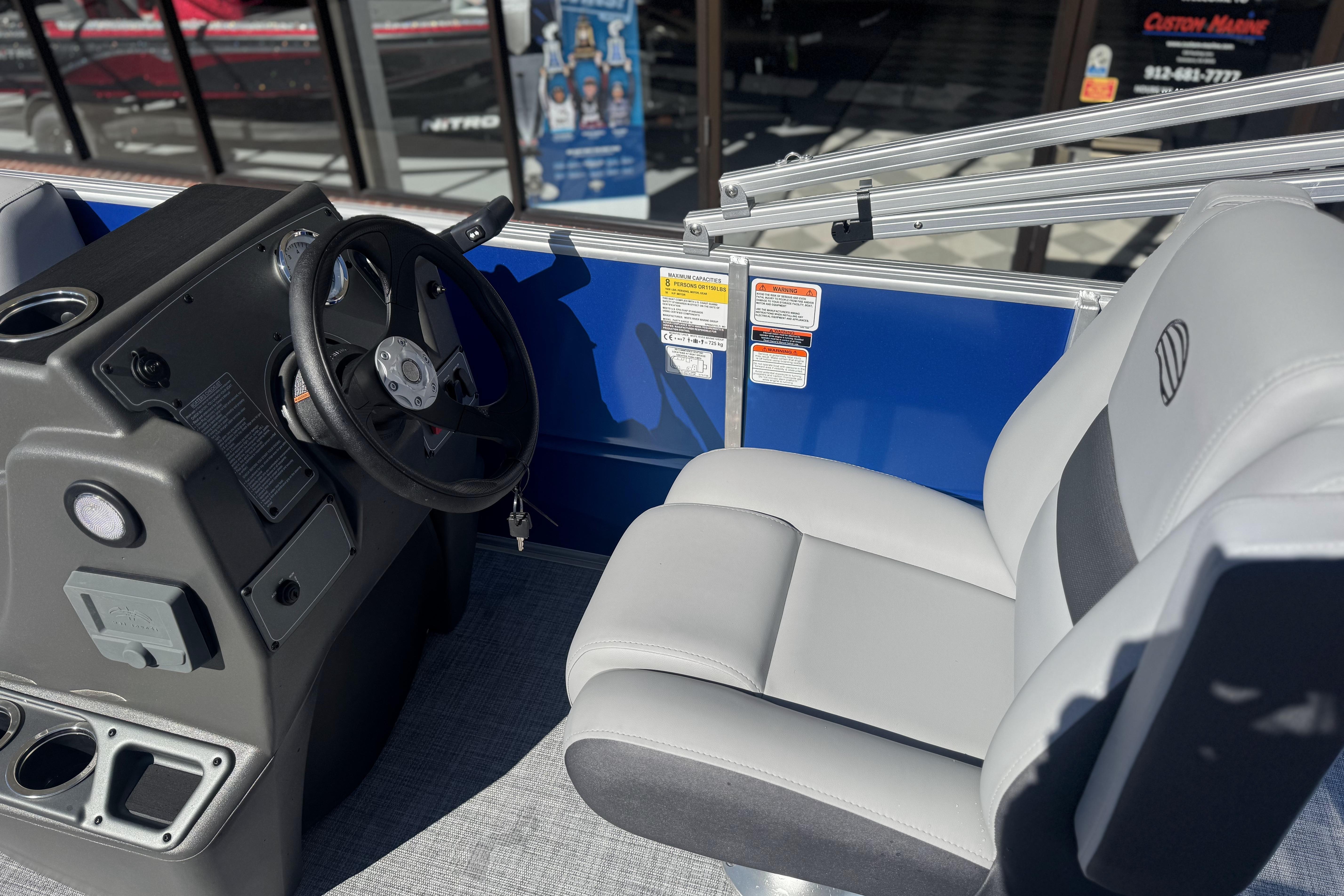 Interior of 2026 Sun Tracker Party Barge 16 DLX with steering wheel and seating.