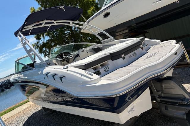 2023 Chaparral 21 SSi boat with sleek design, docked near a serene waterfront.