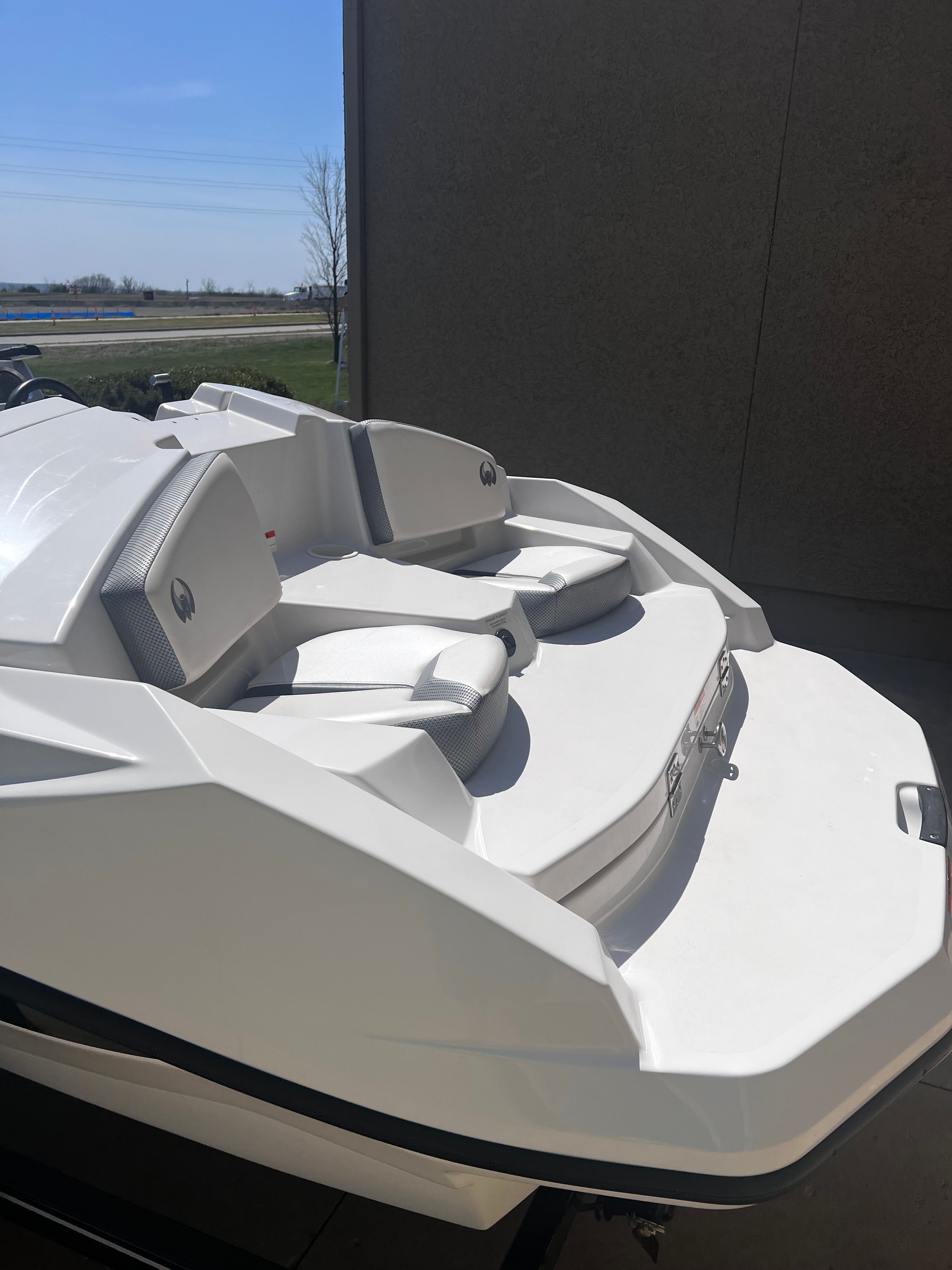 A white Scarab 165 G boat is on a trailer, ready for the water.