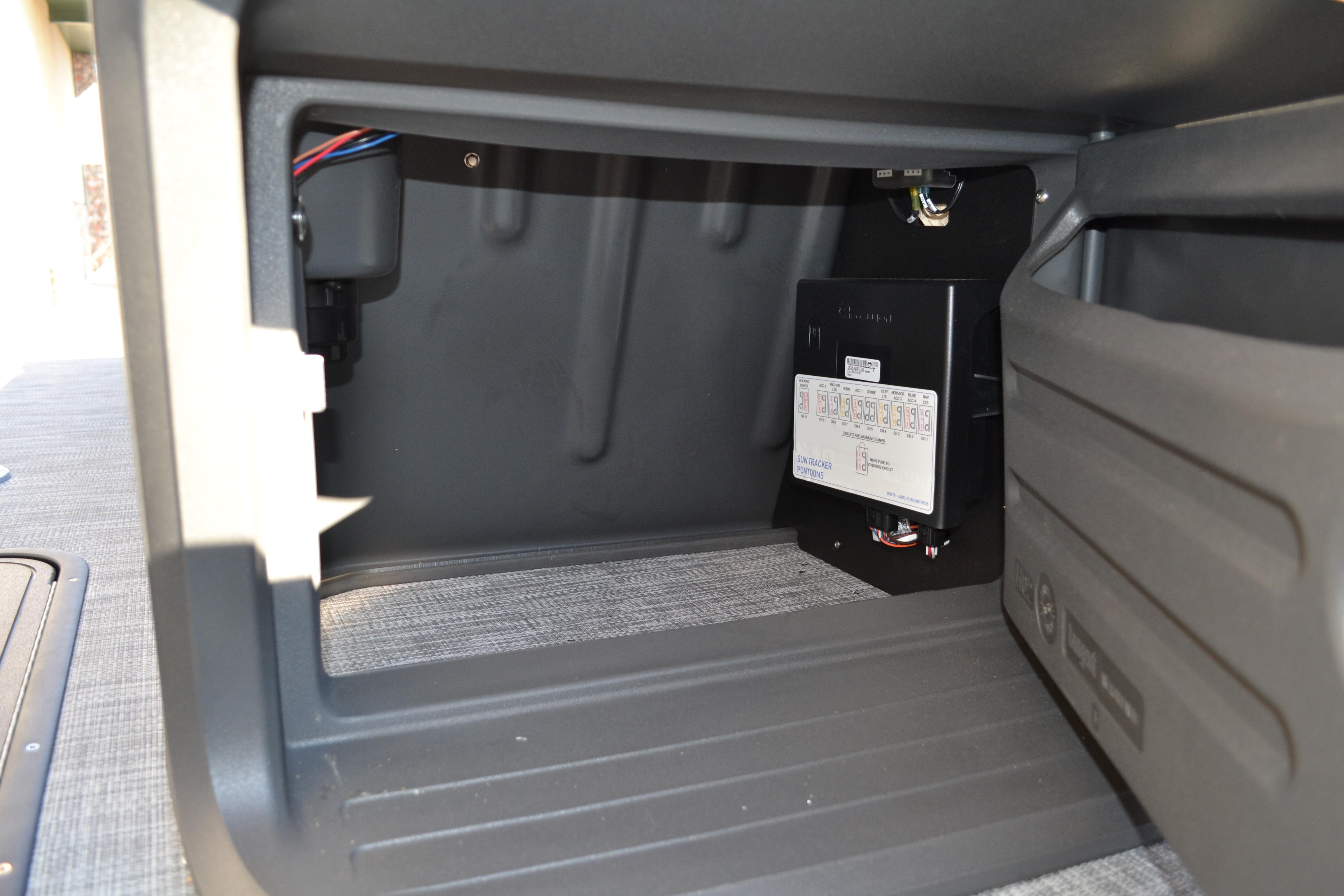 Interior view of 2026 Sun Tracker SportFish 22 XP3, showcasing electrical components.