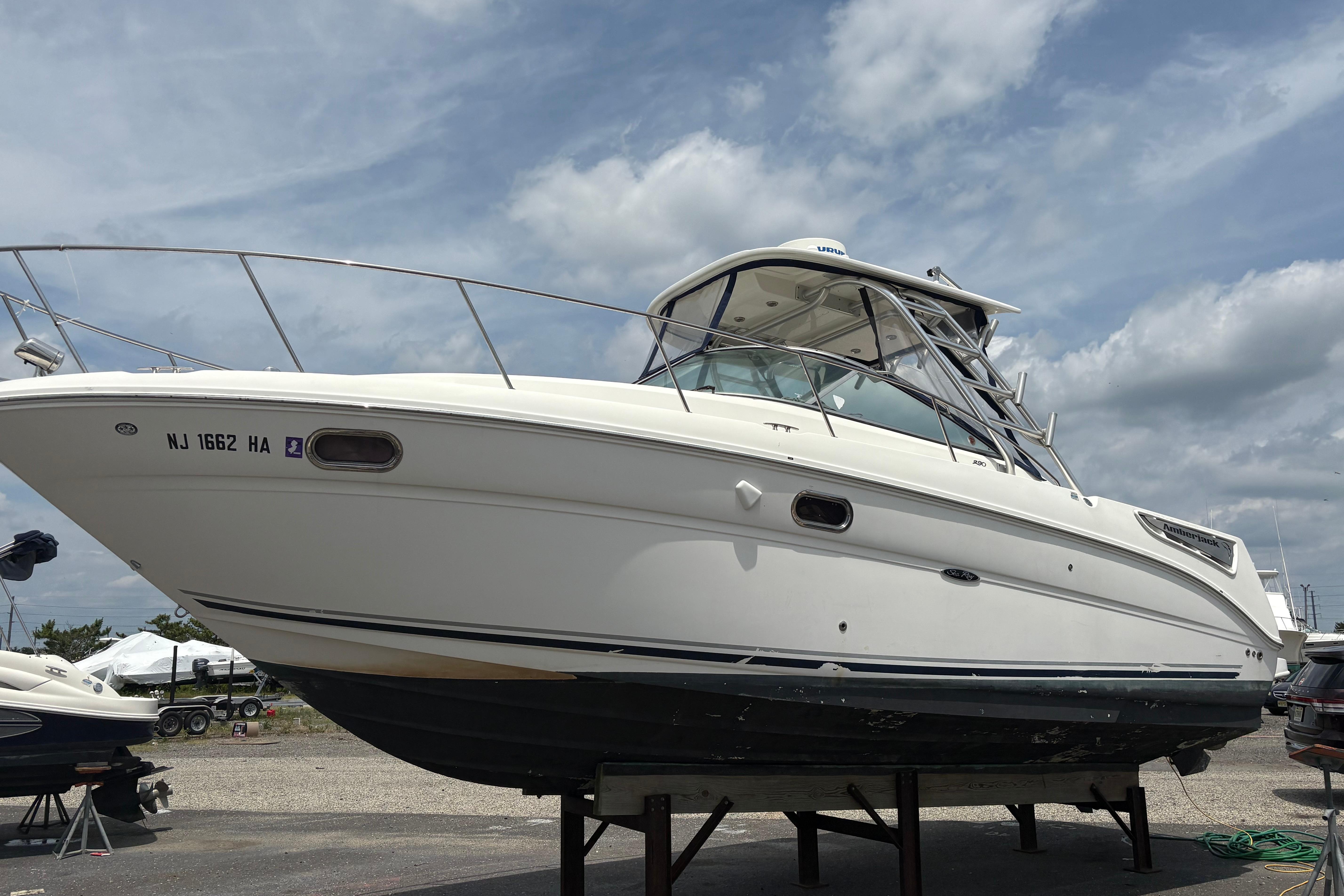 2008 Searay 290 AMBERJACK boat on dry dock under cloudy sky.