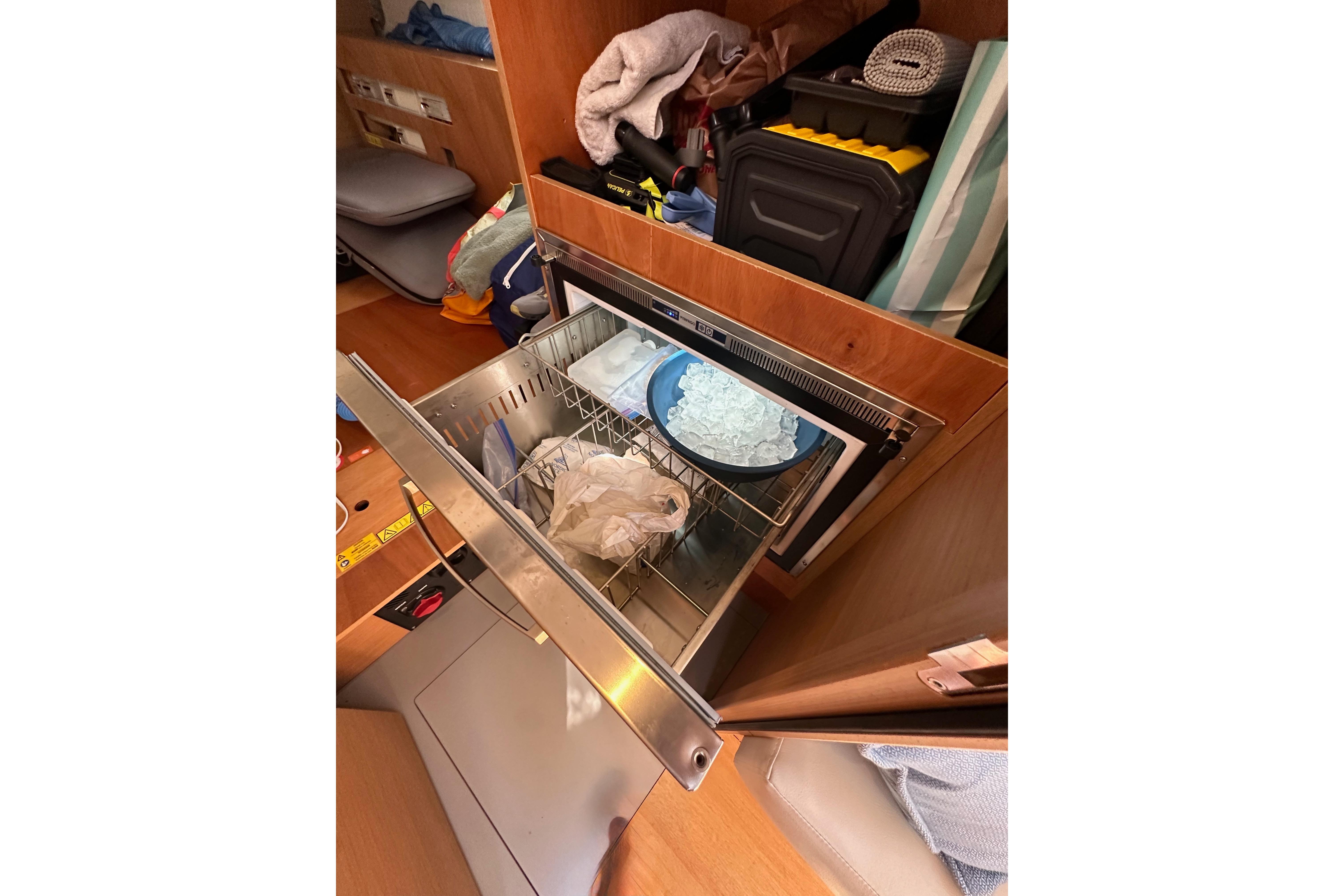 Interior of 2024 Jeanneau Sun Odyssey 410 with open drawer and storage items.
