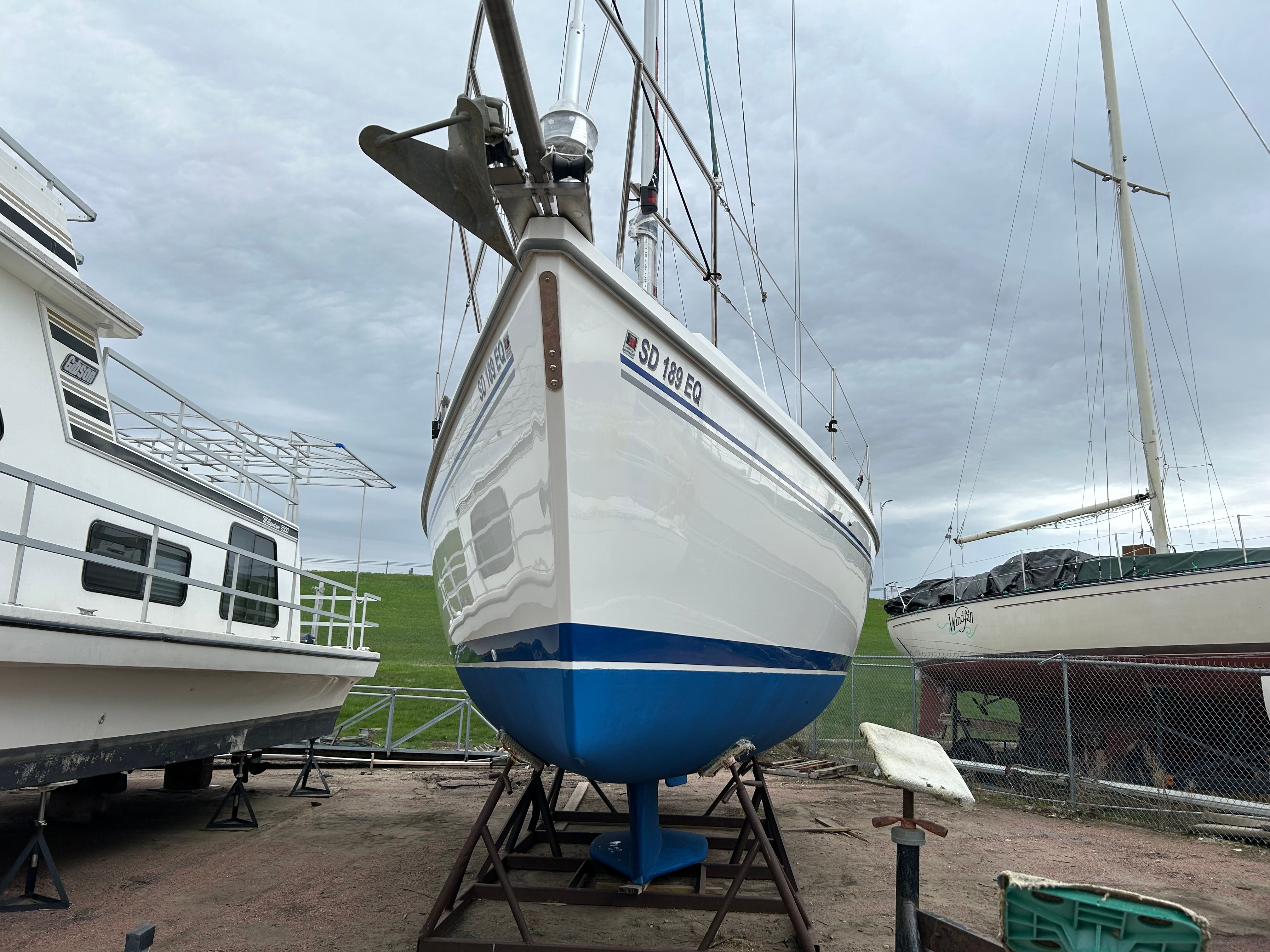 A 2004 Catalina 350 boat is on a dry dock next to other boats.