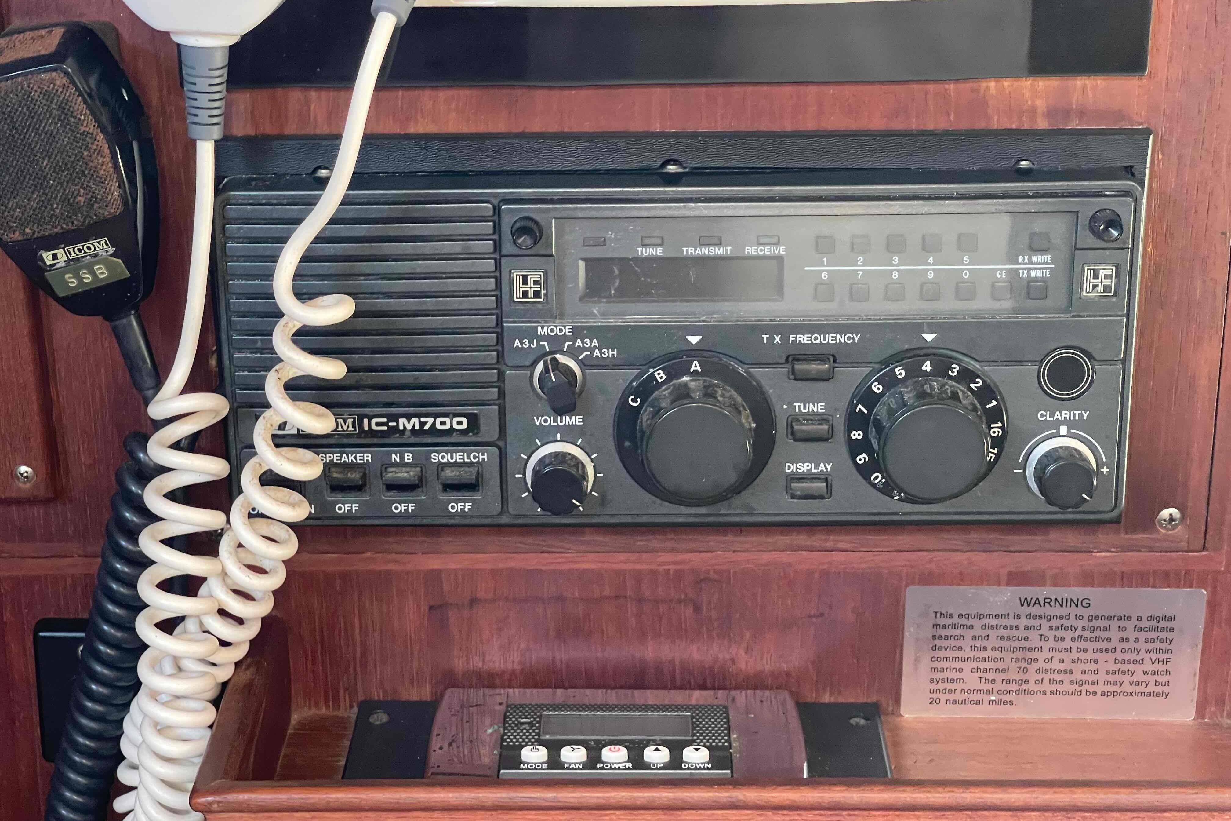 Icom IC-M700 radio on 1989 Island Packet 35 sailboat, featuring controls and microphone.