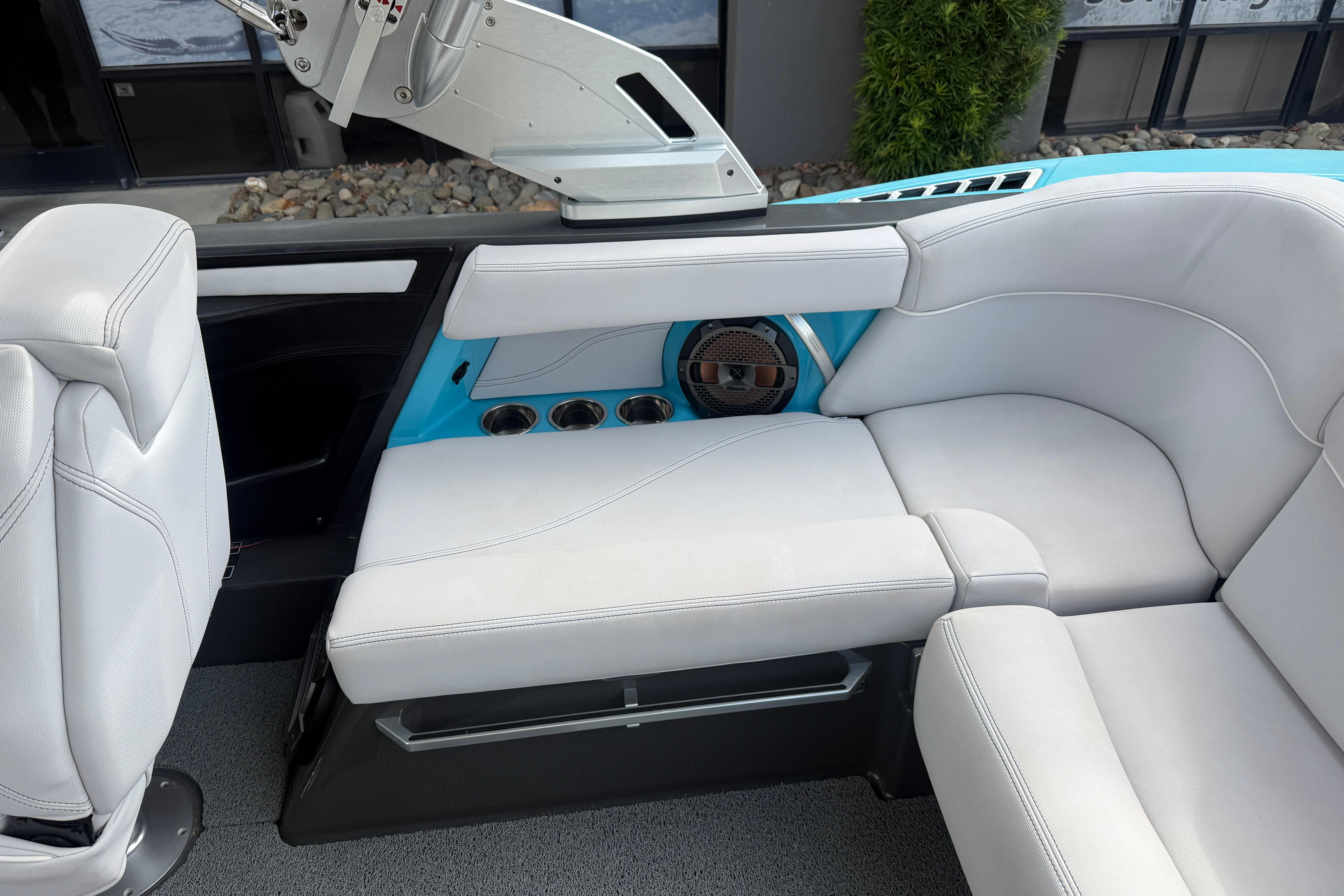 2018 MasterCraft XT21 interior with white seating and cup holders.