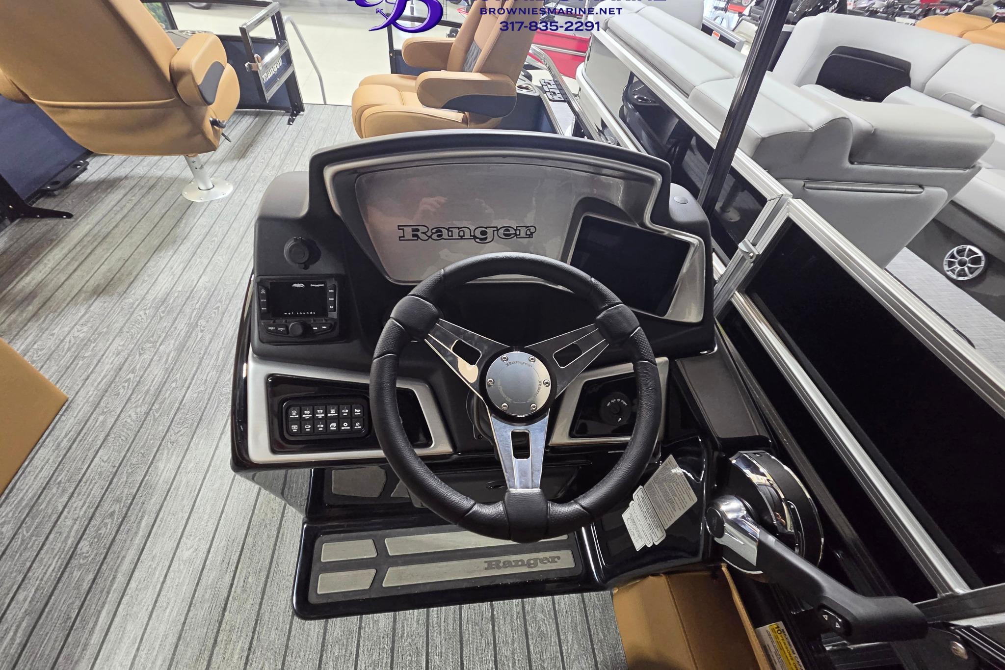 2026 Ranger 220F boat dashboard with steering wheel and control panel in showroom.
