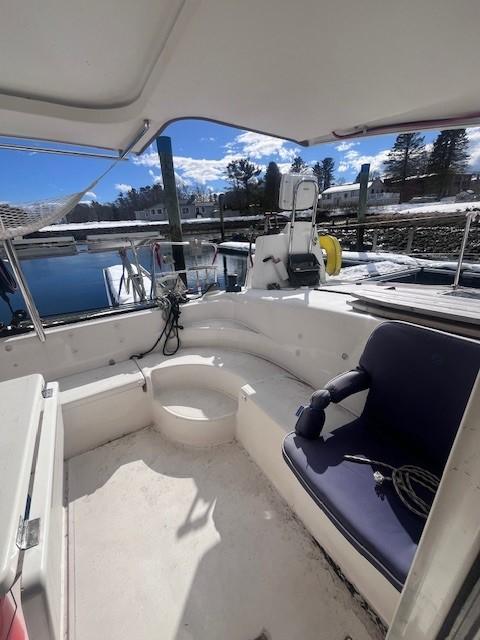 2011 Nautitech 402 yacht cockpit with seating, docked by a scenic waterfront.