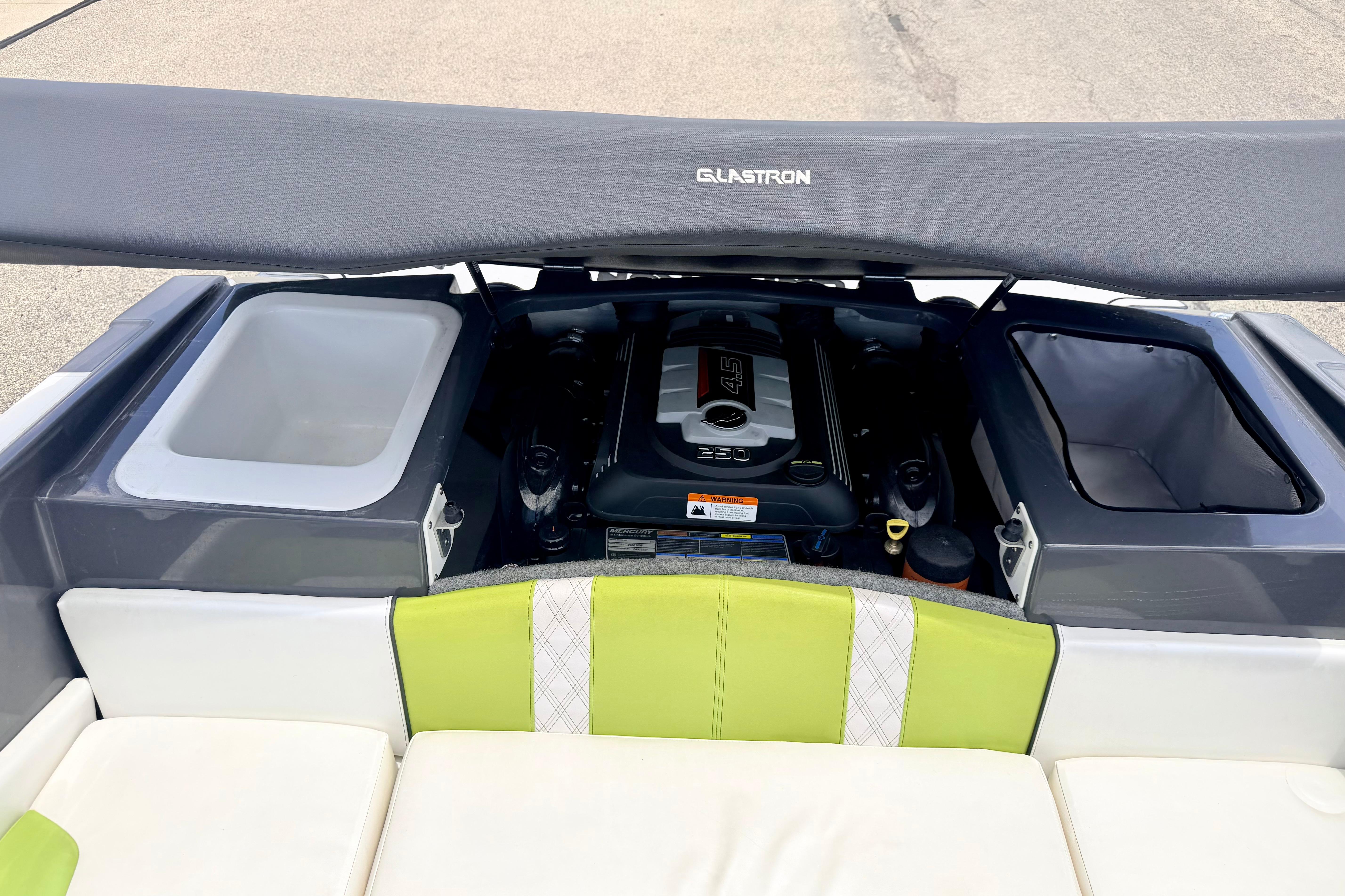 2018 Glastron GT 185 boat engine compartment with seating and storage areas.