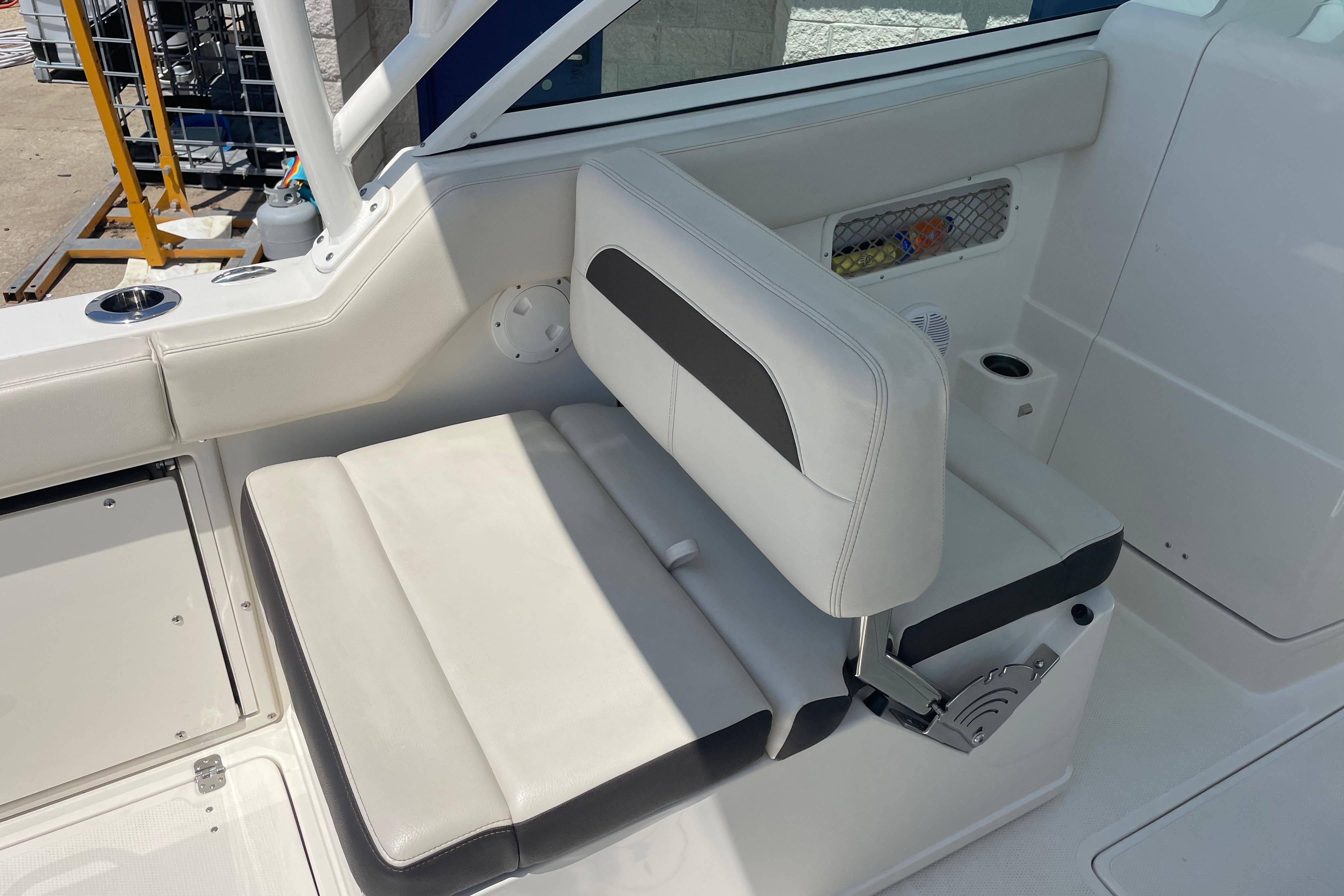 2022 Sailfish 245 DC boat interior with white seating and cup holder.