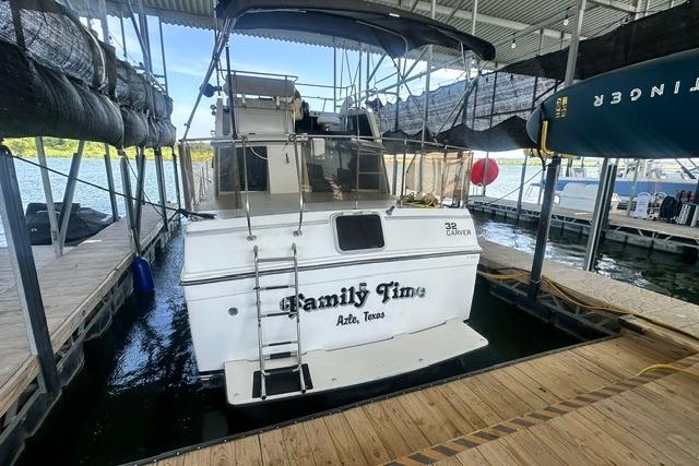 1989 Carver 32 Aft Cabin Motor Yacht docked, named "Family Time," in a marina setting.