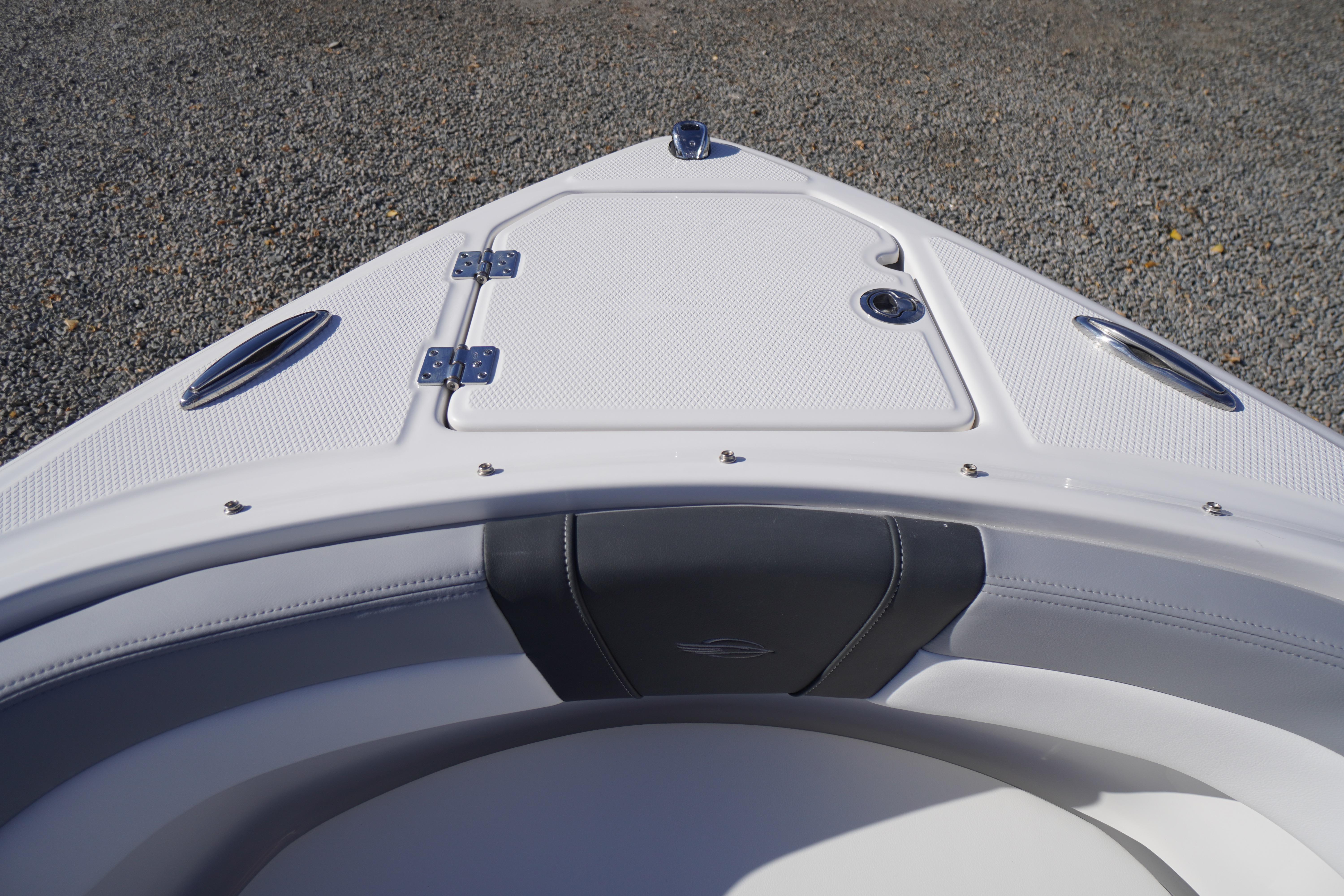 Bow of 2026 Chaparral 23 SSi OB boat with storage compartment and sleek design.