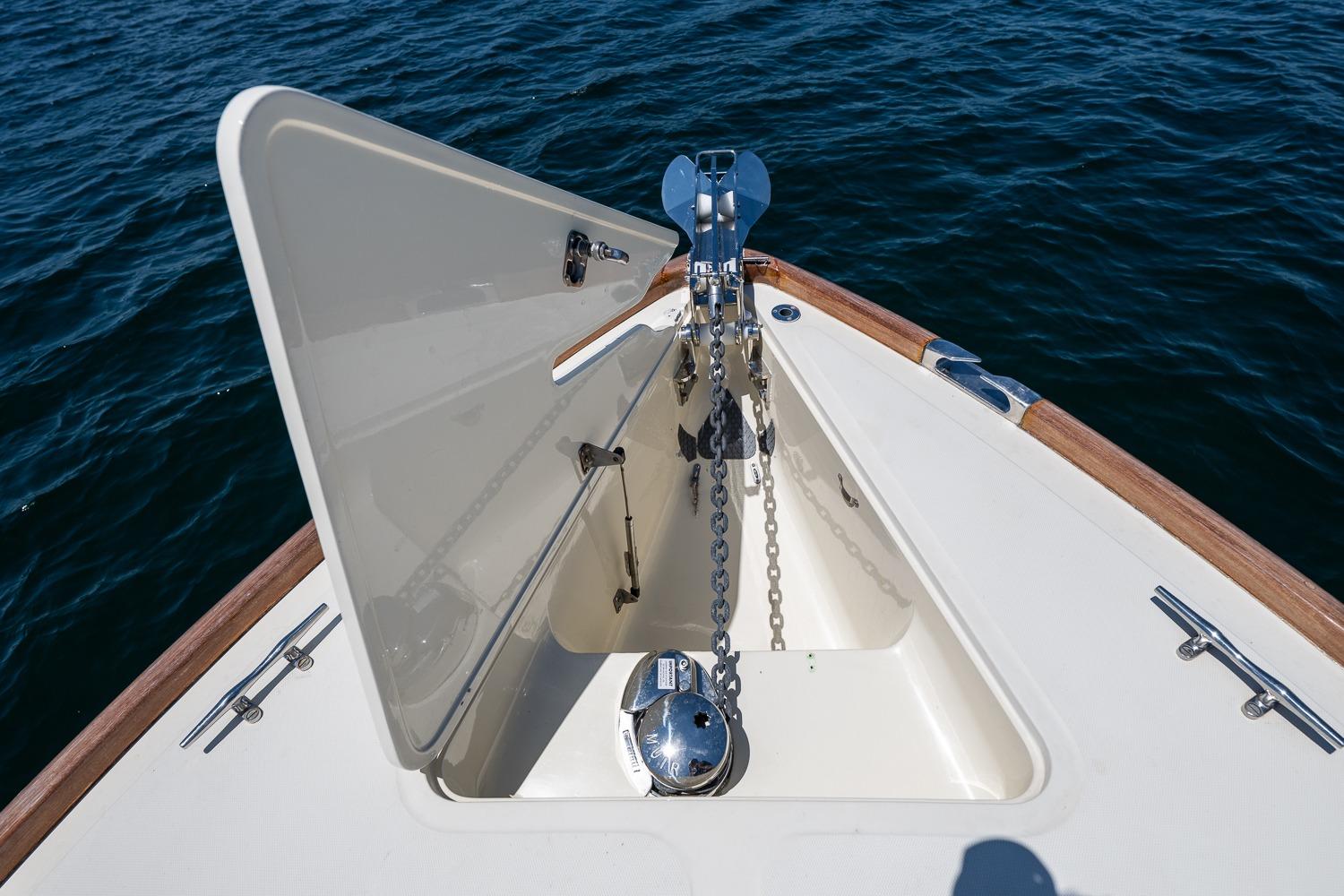 Bow anchor compartment of 2001 Hinckley Picnic Boat 36 Classic on water.