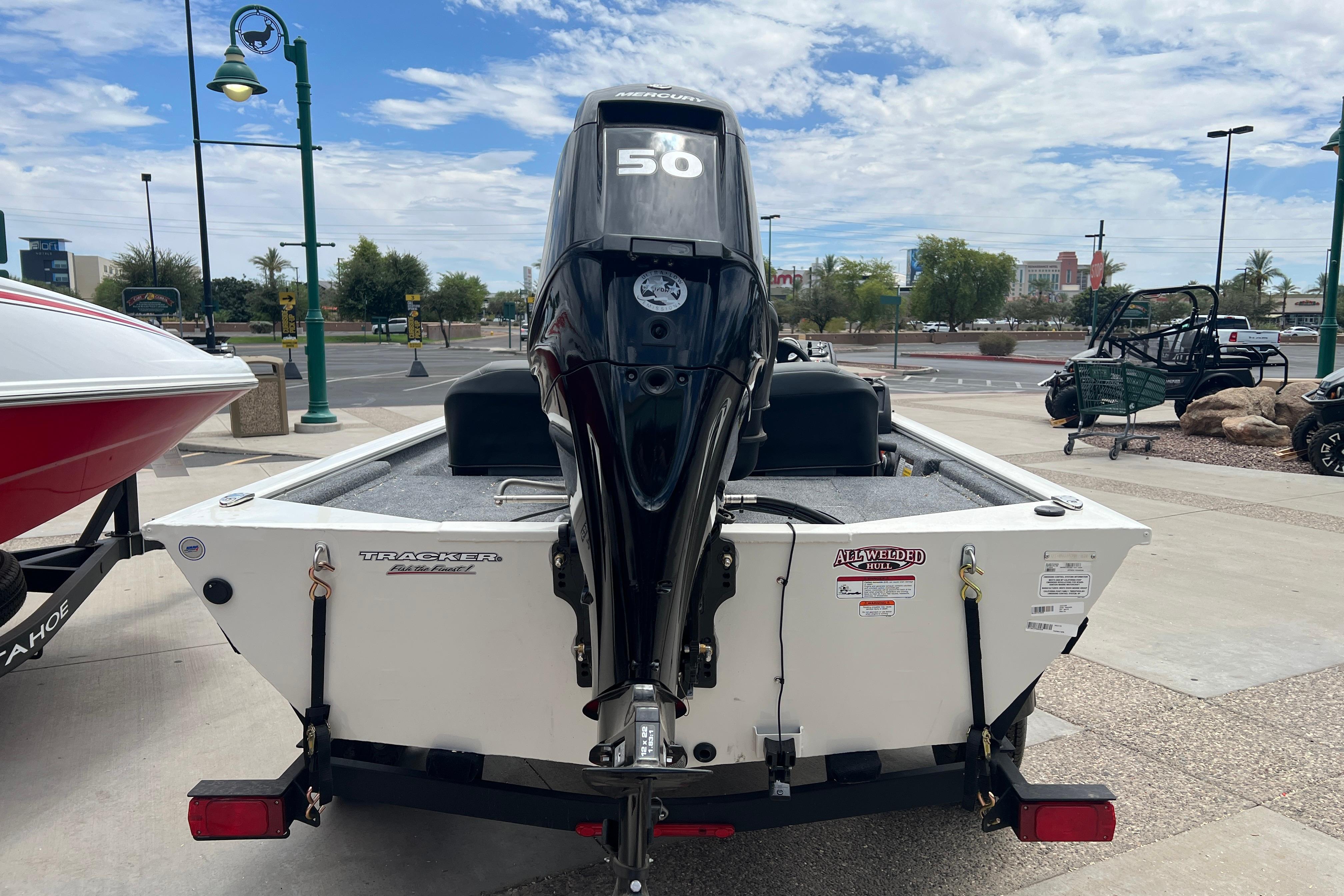 2026 Tracker Pro 170 boat with a 50 HP outboard motor, parked outdoors.
