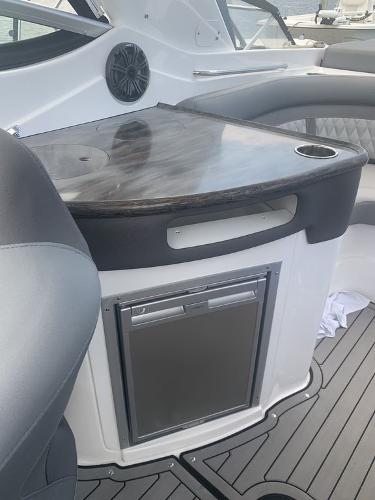 2020 Rinker 29QX BR boat interior with mini fridge and countertop.