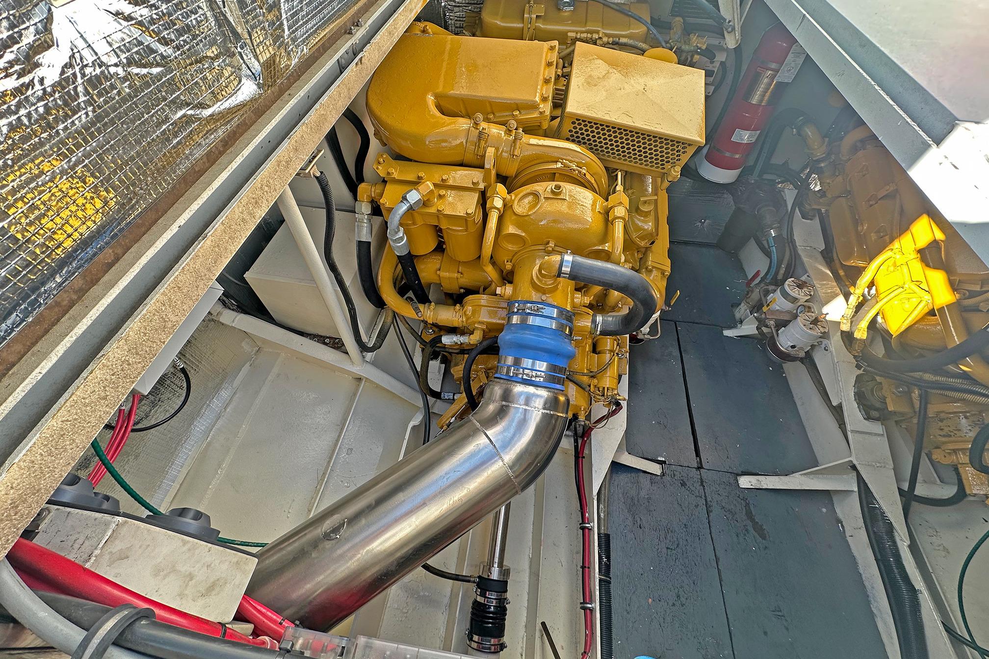 Engine compartment of a 1990 Boston Whaler 36 Defiance, showcasing detailed mechanical components.