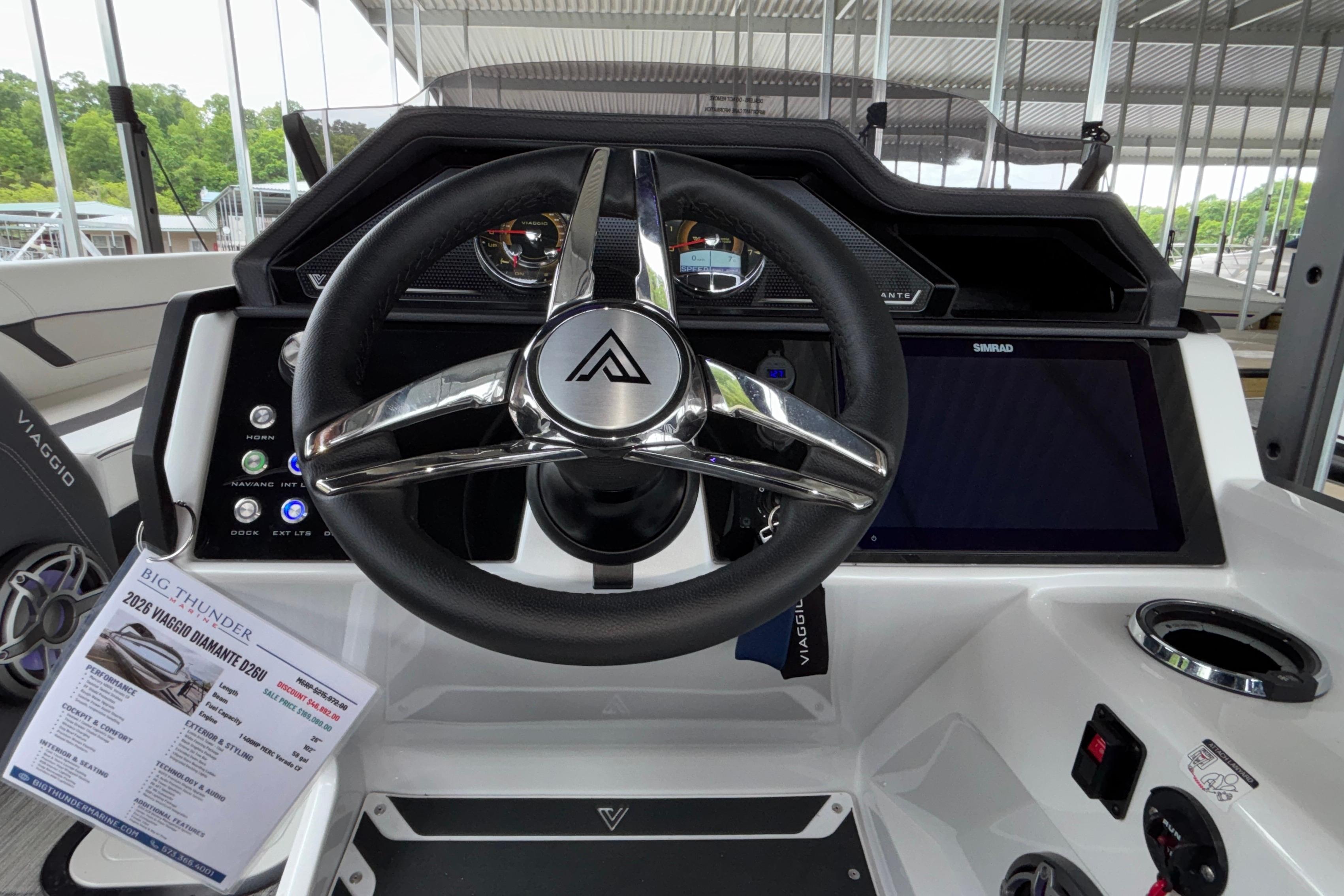 Steering wheel and dashboard of 2026 Viaggio D26U boat, featuring modern controls and display.