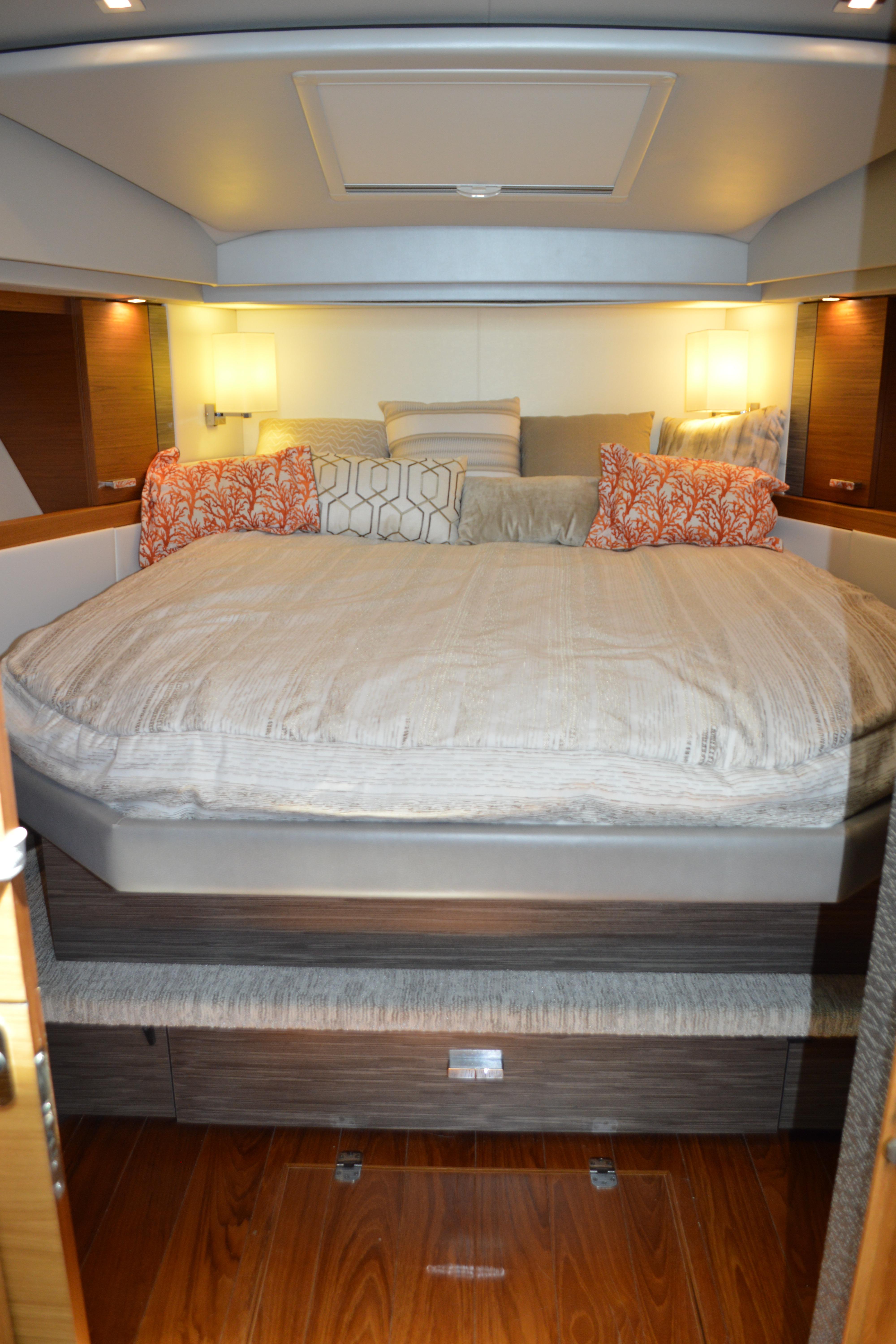 Luxurious bedroom interior of 2019 Tiara Yachts C39 Coupe with elegant bedding and ambient lighting.