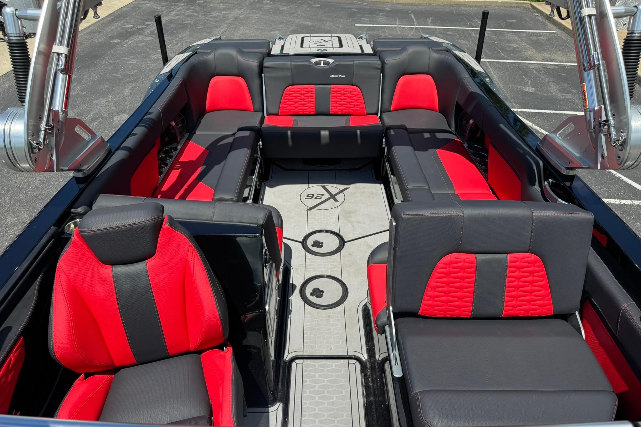 2021 MasterCraft X26 boat interior with red and black seating, showcasing luxury design.