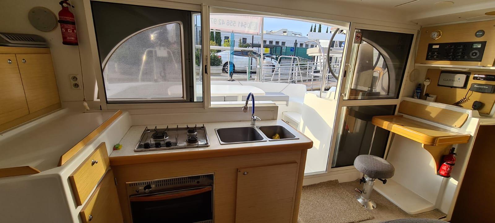 Interior of 2012 Lagoon 380 S2 catamaran with kitchen and navigation area.