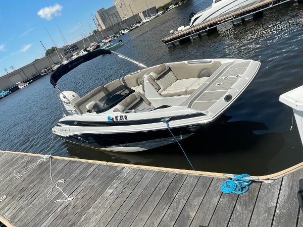 2020 Crownline E 205 XS boat docked at marina on sunny day.
