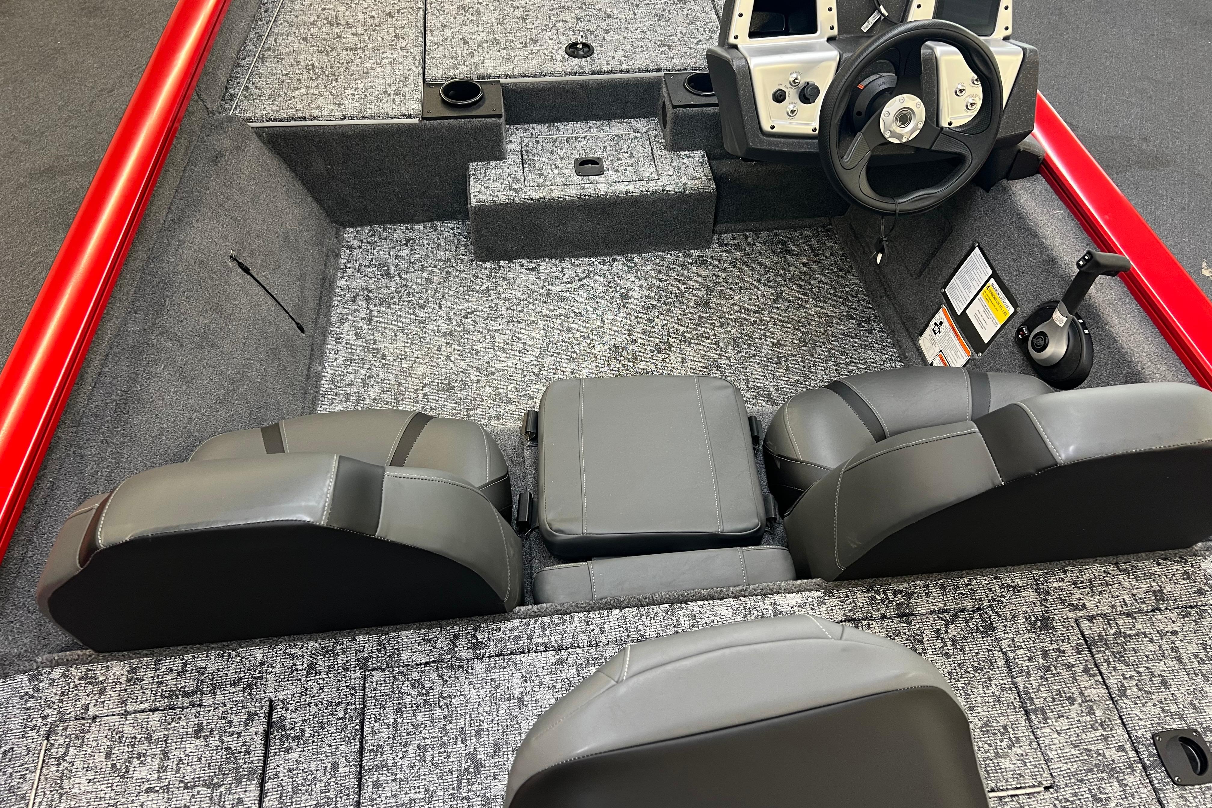 Interior of 2026 Tracker Pro Team 190 boat with gray seating and steering console.
