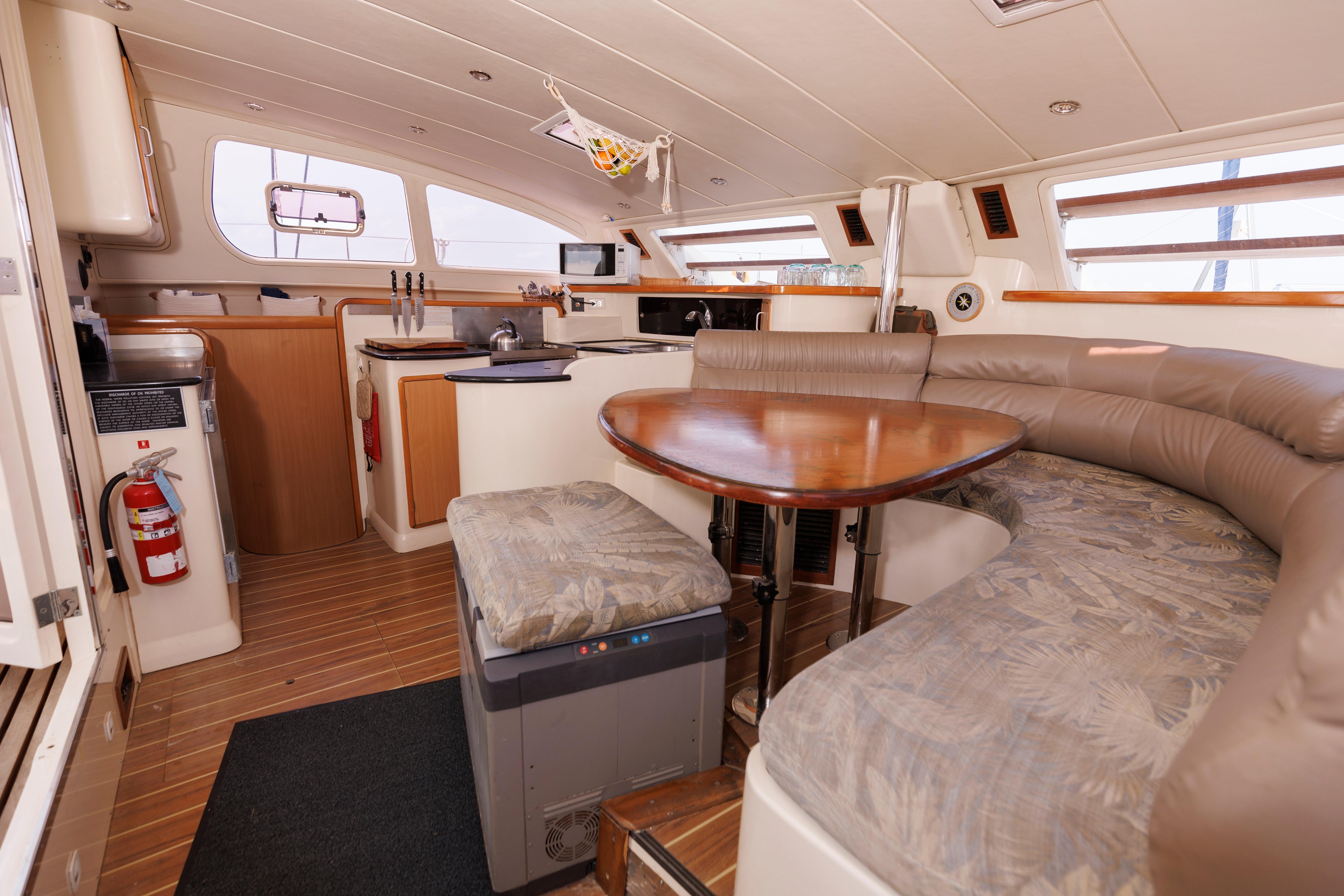 Interior of a 2006 Leopard 43 yacht featuring a cozy dining area and modern kitchen.