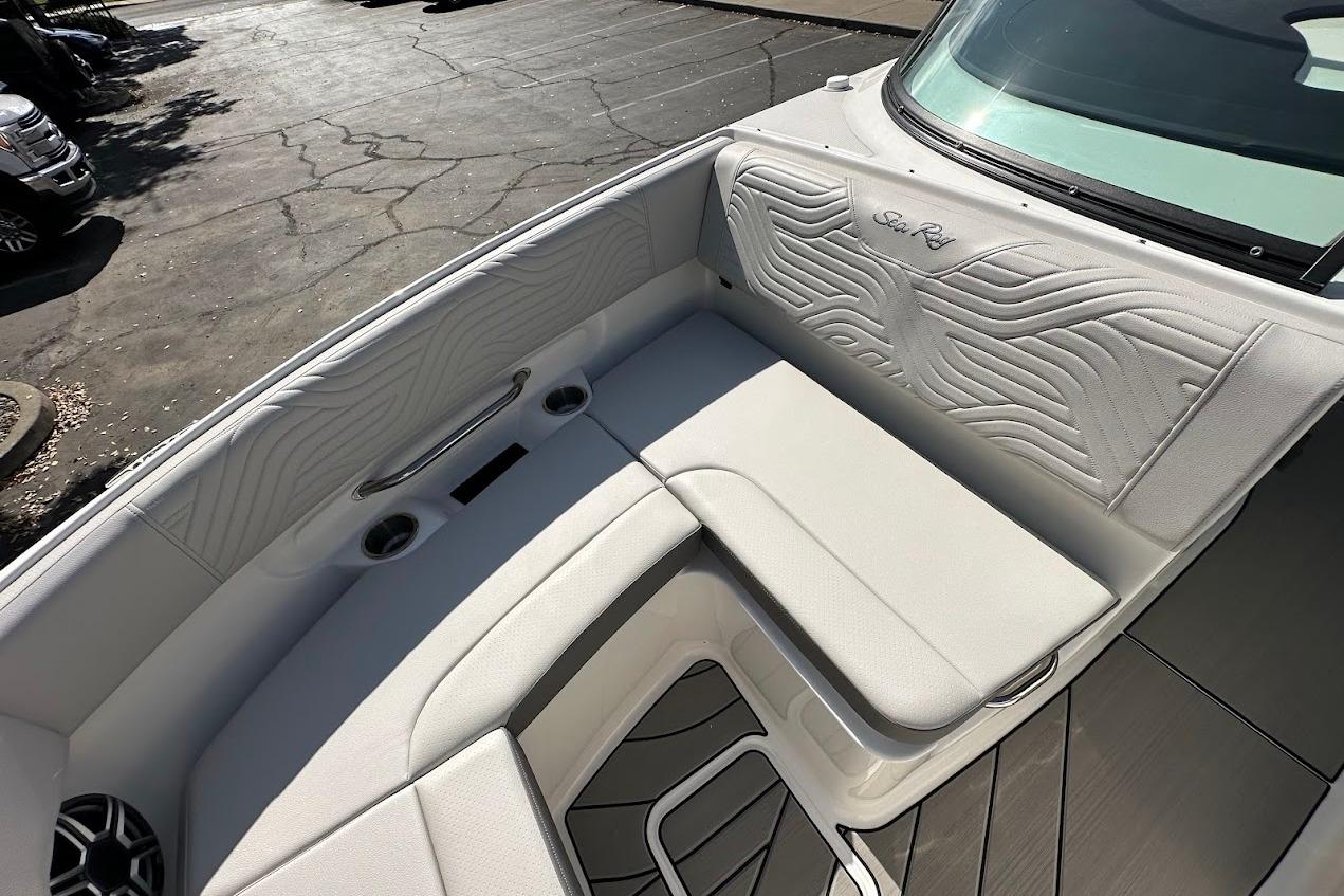 2026 Sea Ray SDX 230 Surf boat interior with white cushioned seating and sleek design.