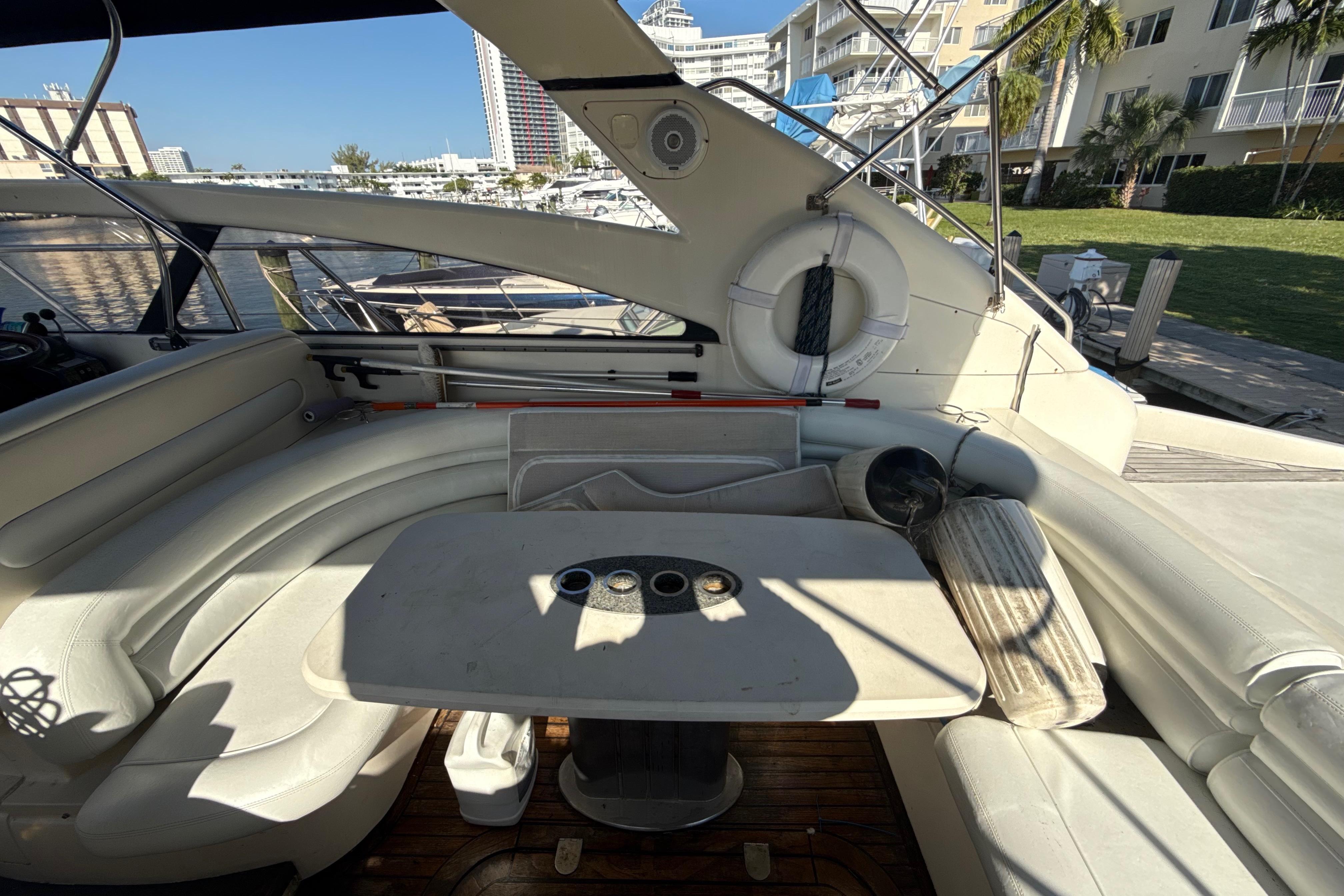 Luxurious 2002 Viking Princess V50 yacht interior with white seating and table.